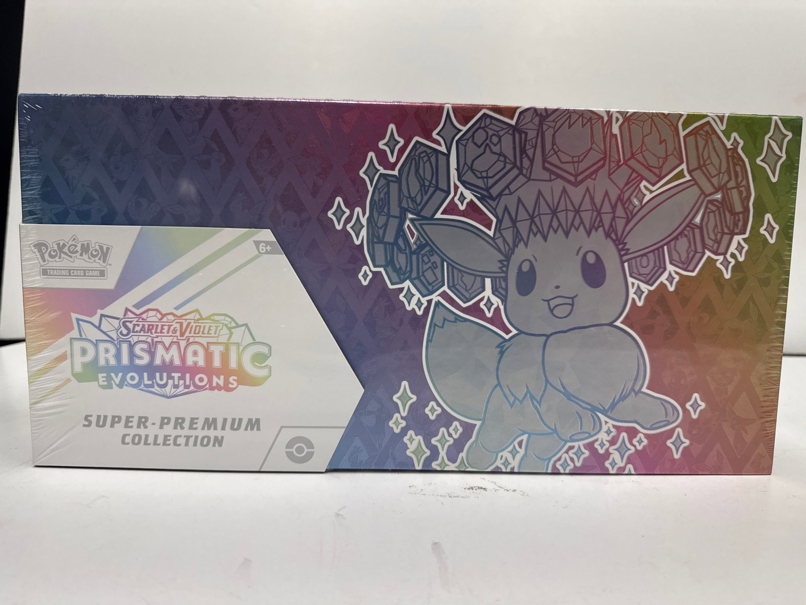Pokemon TCG Scarlet & Violet Prismatic Evolutions Super-Premium Collection Box: Sealed Pokemon Trading Card Game Super-Premium Collection Box featuring Scarlet & Violet - Prismatic Evolutions. Includes a deck box, card sleeves, and booster packs. Eevee and its Evolutions are prom