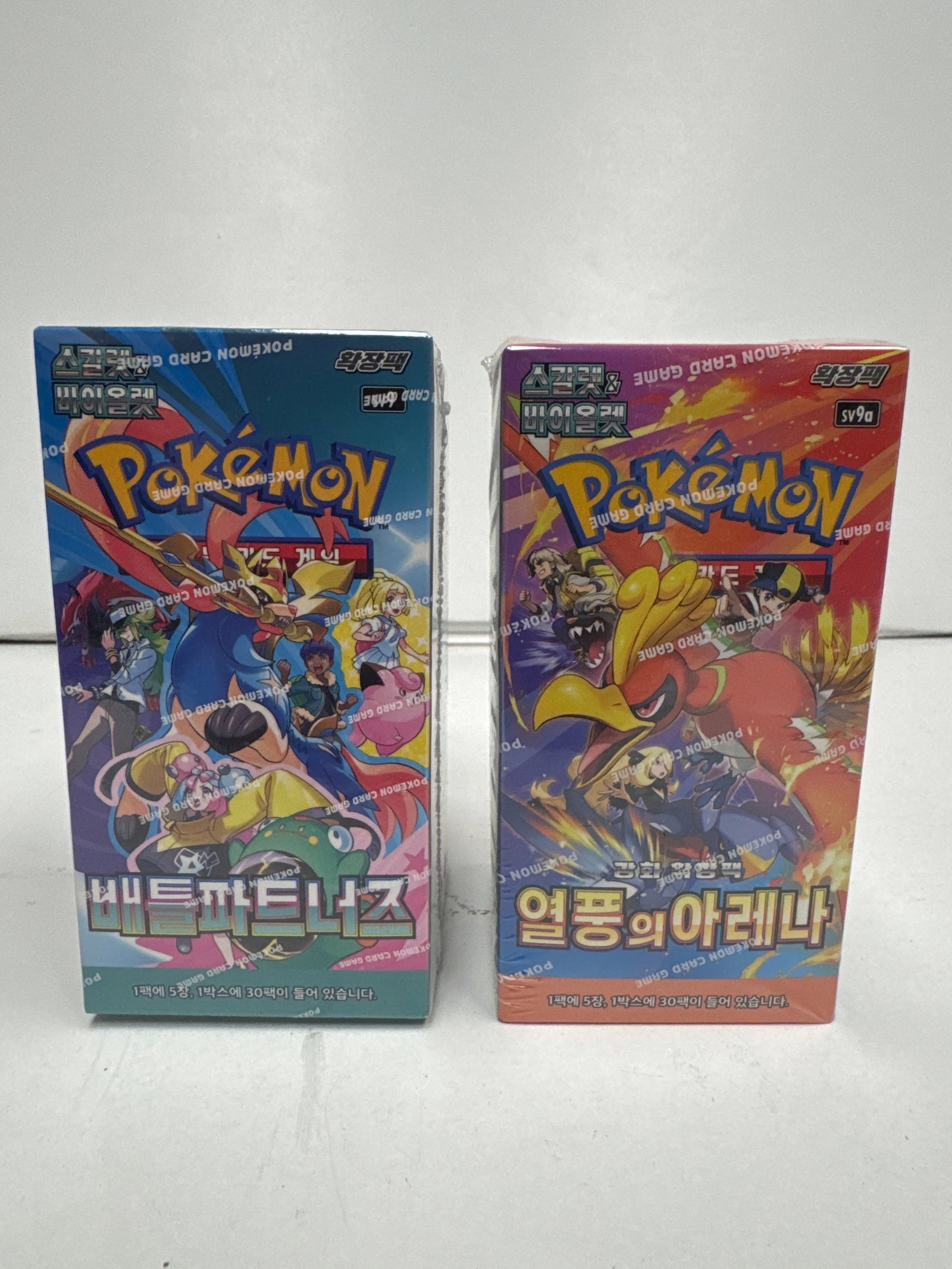 Two Sealed Pokemon Card Game Booster Boxes: Battle Legion & VSTAR Universe: This lot features two sealed Pokemon Card Game booster boxes. The first is the Korean "Battle Legion" set, and the second is the Korean "VSTAR Universe" set. Both boxes appear to be in excellent condi