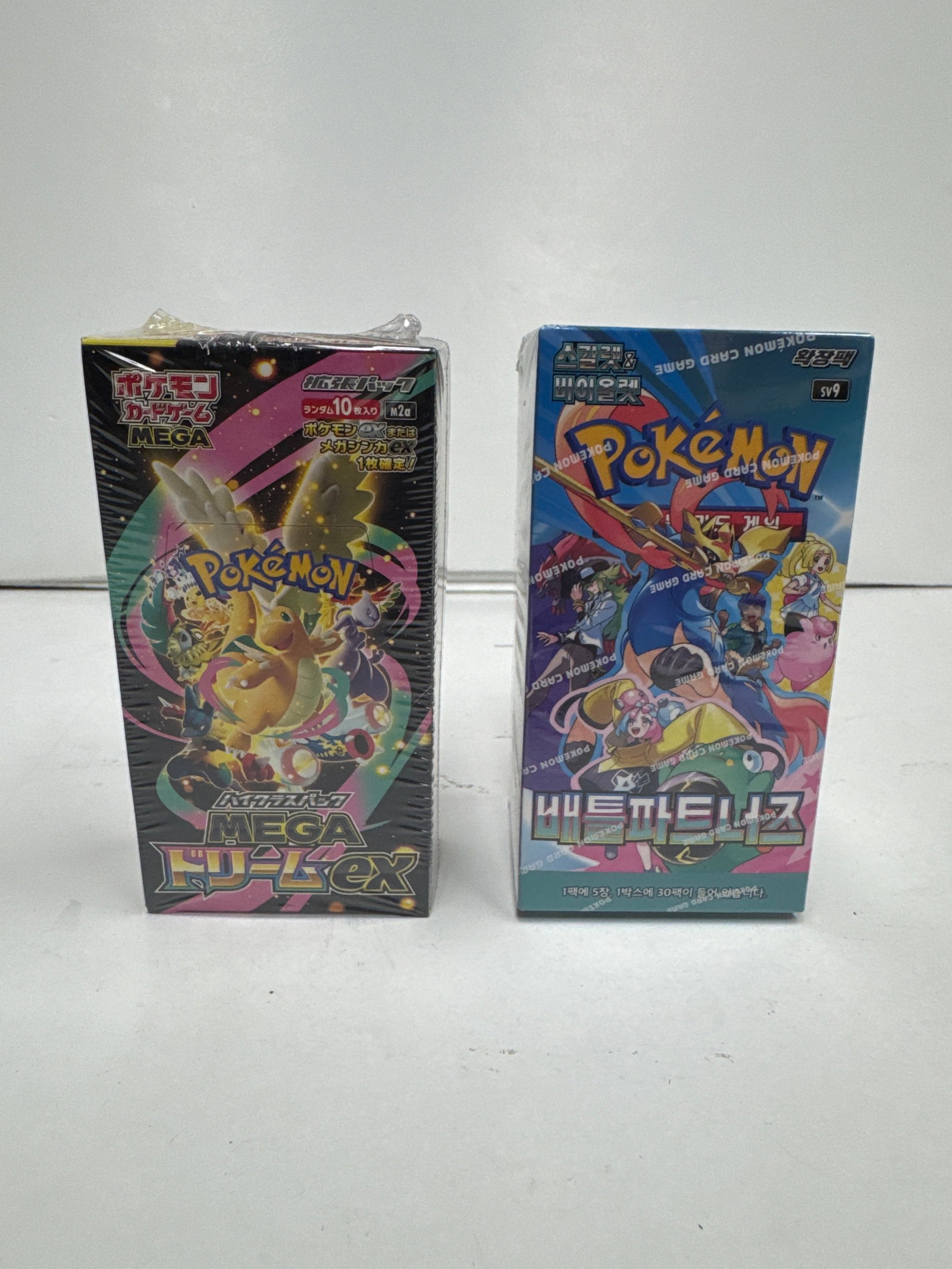 Two Sealed Pokemon Card Game Booster Boxes: Mega Top Deck EX and Battle Style: This lot features two sealed booster boxes for the Pokemon Card Game. The first is the "Mega Top Deck EX" set, a Japanese exclusive, containing 10 packs with 5 cards each. The second is the "Battle St