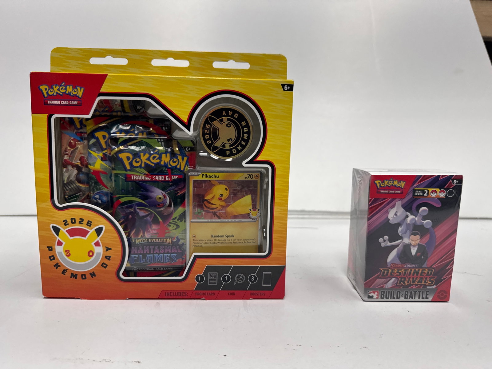 Pokemon TCG: Pokemon Day 2026 Collection Box & Build & Battle Box: This lot includes a Pokemon TCG: Pokemon Day 2026 Collection Box and a Pokemon TCG: Sword & Shield - Brilliant Stars Build & Battle Box. The collection box celebrates 30 years of Pokemon and includes 