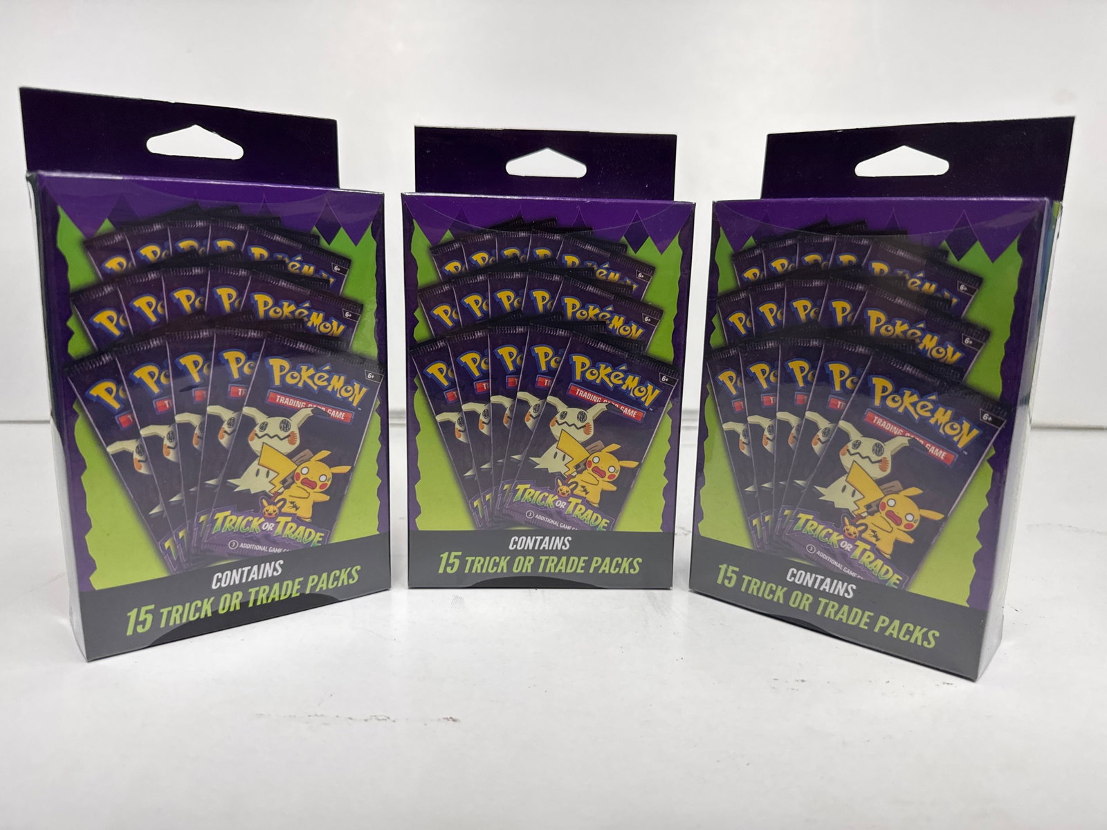 Pokemon Trading Card Game Trick or Trade Booster Packs - 3 Boxes: This lot includes three sealed boxes of Pokemon Trading Card Game Trick or Trade booster packs. Each box contains 15 trick or trade packs, featuring Pikachu and Mimikyu on the packaging. These are ide