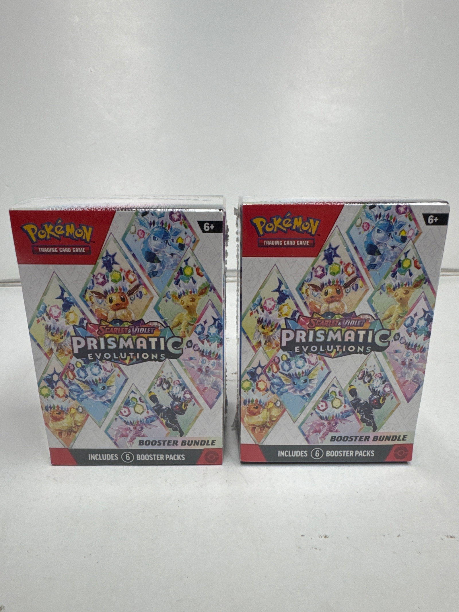 Pokemon TCG Scarlet & Violet Prismatic Evolutions Booster Bundle (2 Boxes): This lot includes two Pokemon TCG Scarlet & Violet Prismatic Evolutions Booster Bundles. Each bundle contains 6 booster packs from the Prismatic Evolutions expansion, featuring Eevee & Friends with St