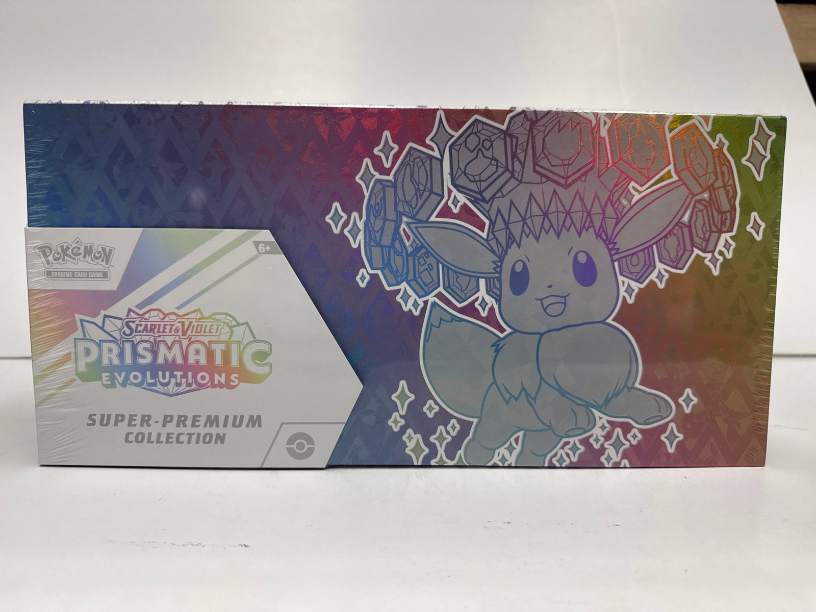 Pokemon Scarlet & Violet Prismatic Evolutions Super-Premium Collection Box: Sealed Pokemon TCG Scarlet & Violet - Prismatic Evolutions Super-Premium Collection. Features Eevee and its Evolutions with a special illustration rare-style promo card, a fuzzy Eevee deck box, card s