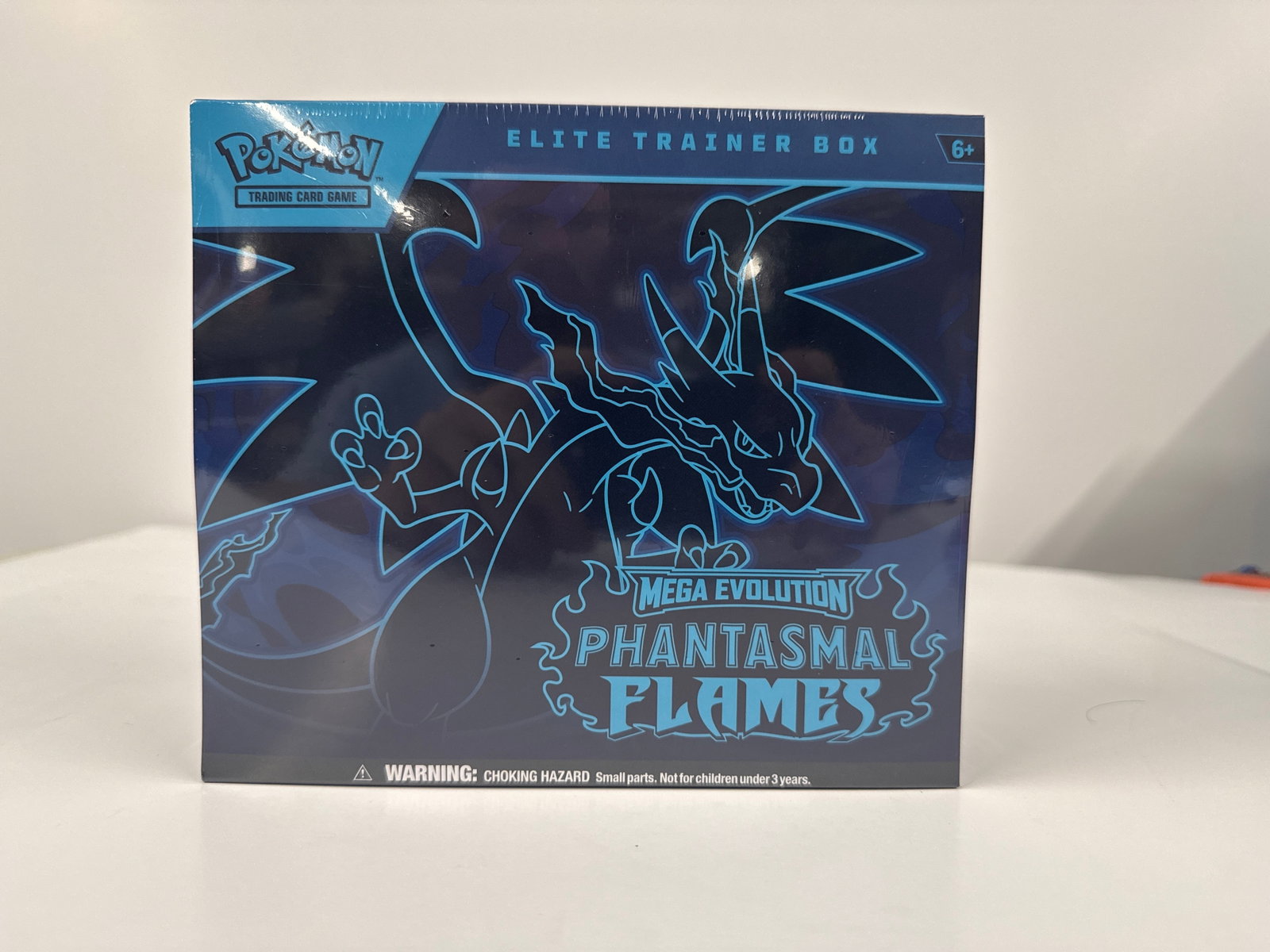 Pokemon TCG: Mega Evolution Phantasmal Flames Elite Trainer Box: Sealed Pokemon TCG: Mega Evolution Phantasmal Flames Elite Trainer Box. Includes 10 booster packs, energy cards, player's guide, damage-counter dice, competition-legal coin-flip die, plastic coin, col