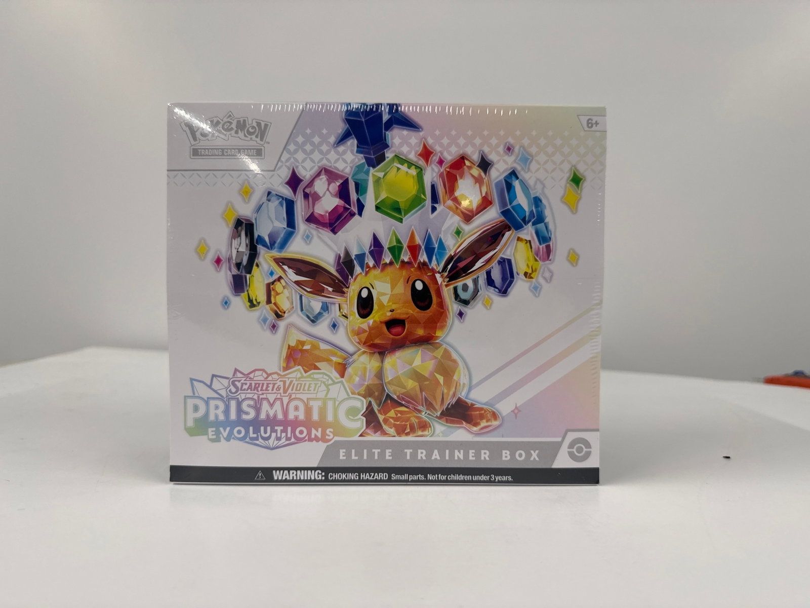 Pokemon TCG Scarlet & Violet Prismatic Evolutions Elite Trainer Box: Sealed Pokemon Trading Card Game Elite Trainer Box from the Scarlet & Violet Prismatic Evolutions expansion. Features Eevee on the cover and includes booster packs, energy cards, sleeves, and more.