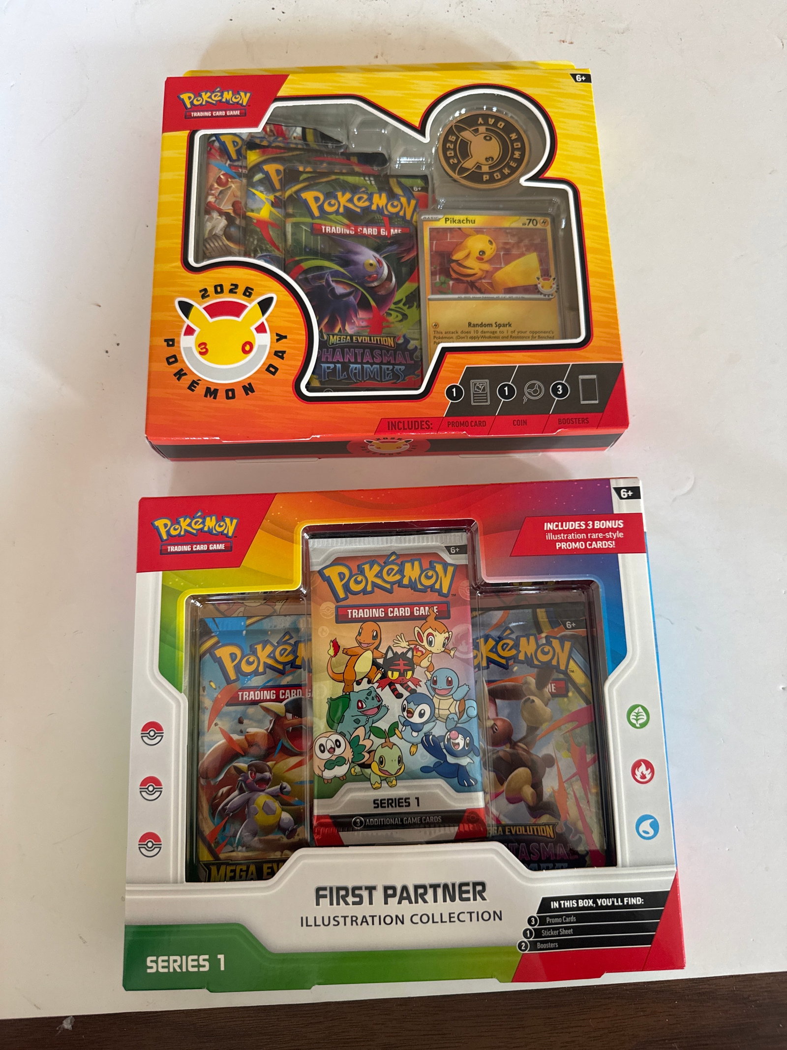Pokemon Trading Card Game: Pokemon Day 2026 & First Partner Illustration Collection: This lot includes two Pokemon Trading Card Game collections: the Pokemon Day 2026 30th Anniversary collection featuring a promo card, coin, and three booster packs, and the First Partner Illustration 