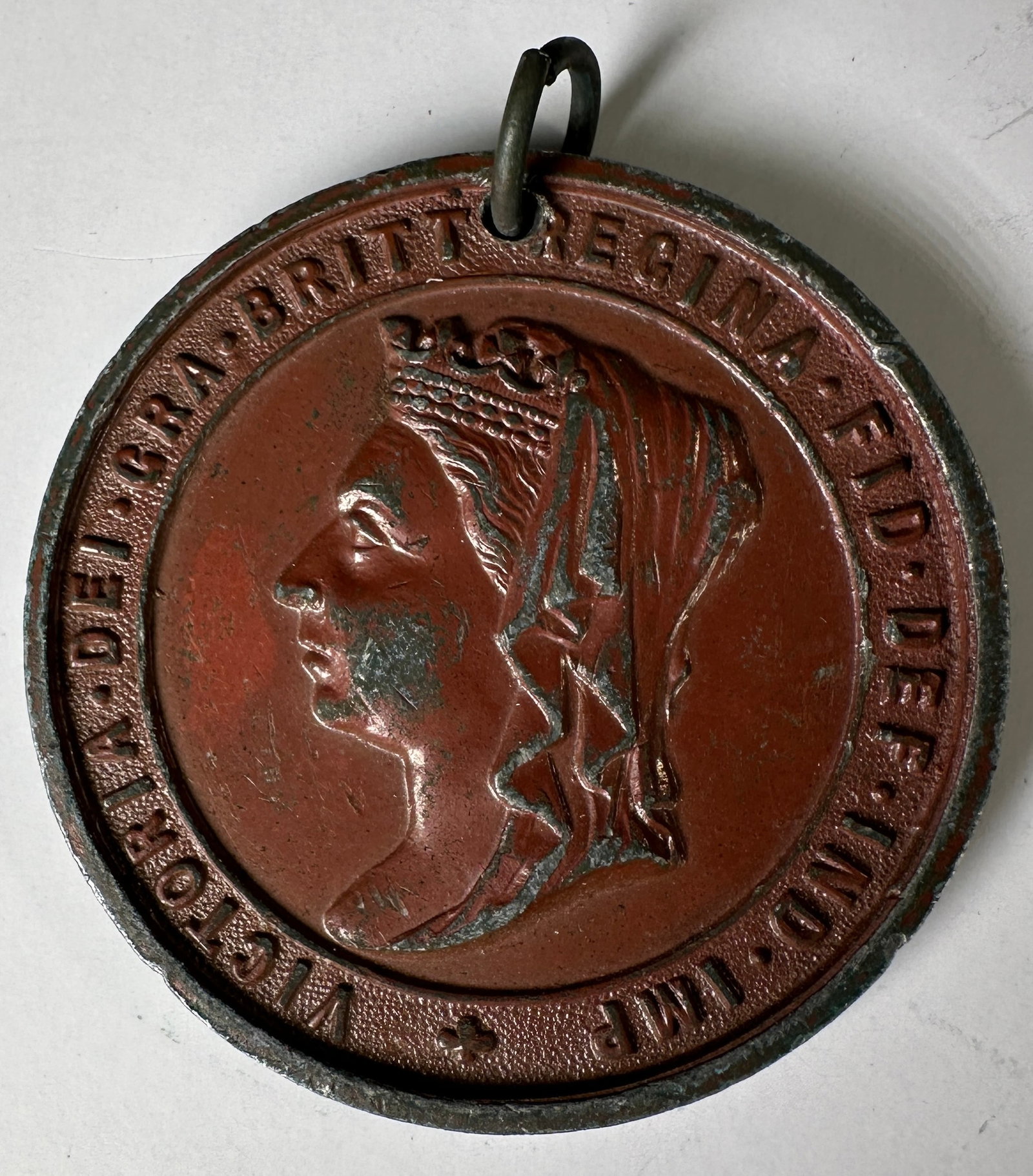 Queen Victoria 1837-1897 Jubilee Medal: Queen Victoria Jubilee medal, commemorating 60 years of reign, 1837-1897. Features a portrait of Queen Victoria on one side and a coat of arms on the other. Includes loop for wear.