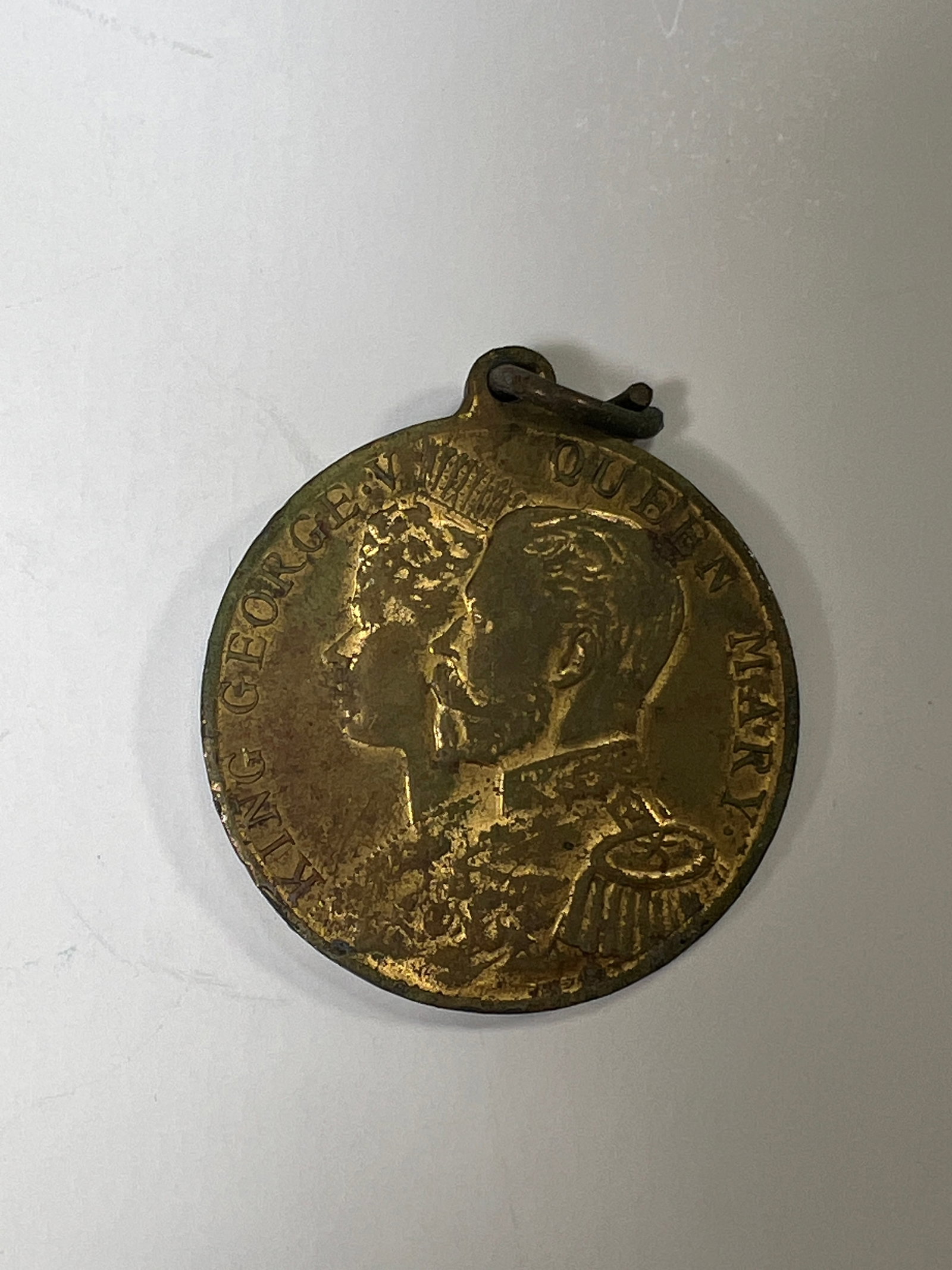 King George VI & Queen Mary Coronation Medal 1911: Commemorative medal for the coronation of King George VI and Queen Mary in 1911. Features portraits of the King and Queen on one side and a royal emblem on the other. Metal loop for suspension.