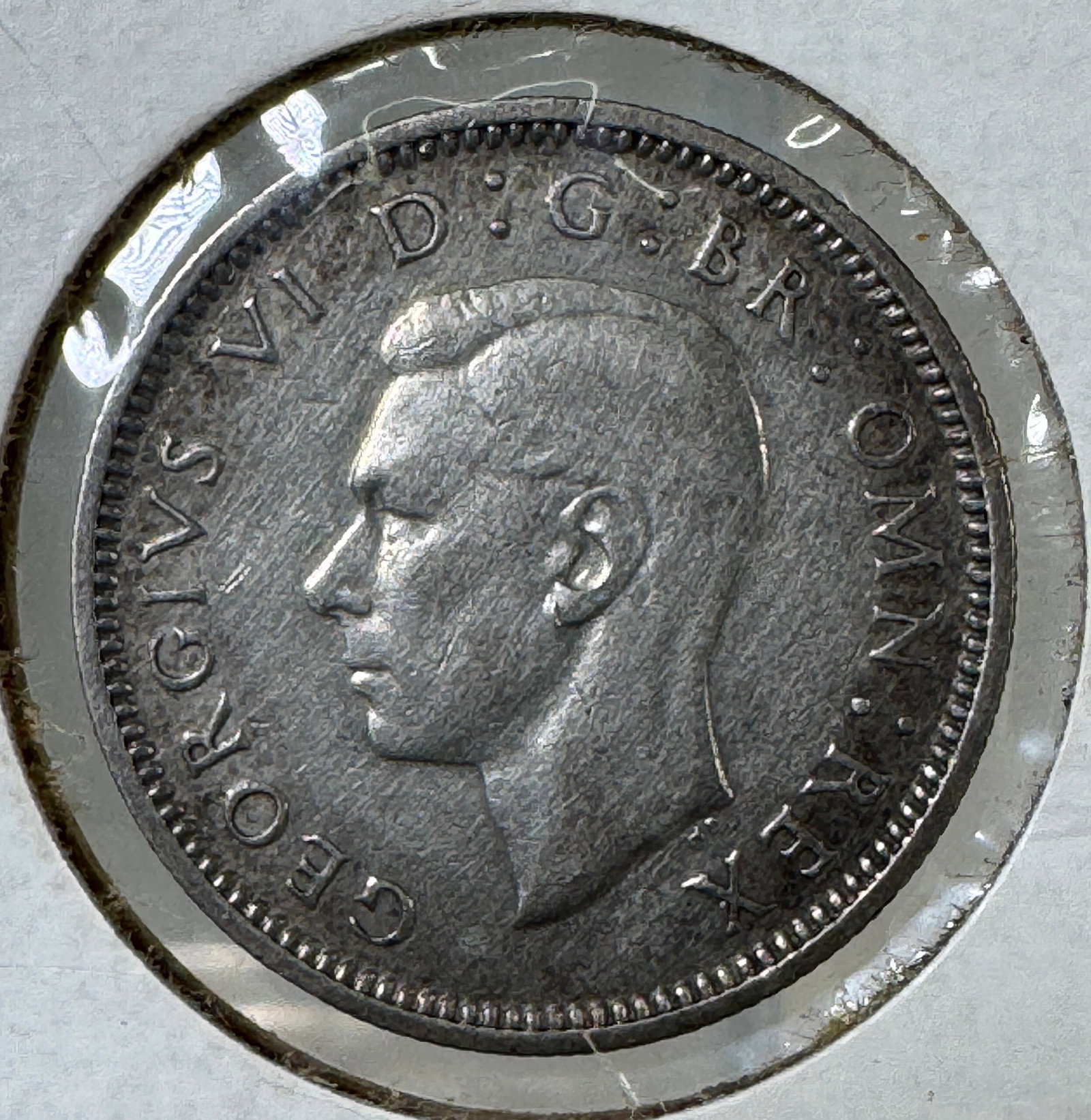 1945 British Sixpence Coin - 500 Silver: 1945 British Sixpence coin featuring King George VI. Coin is 500 silver. 