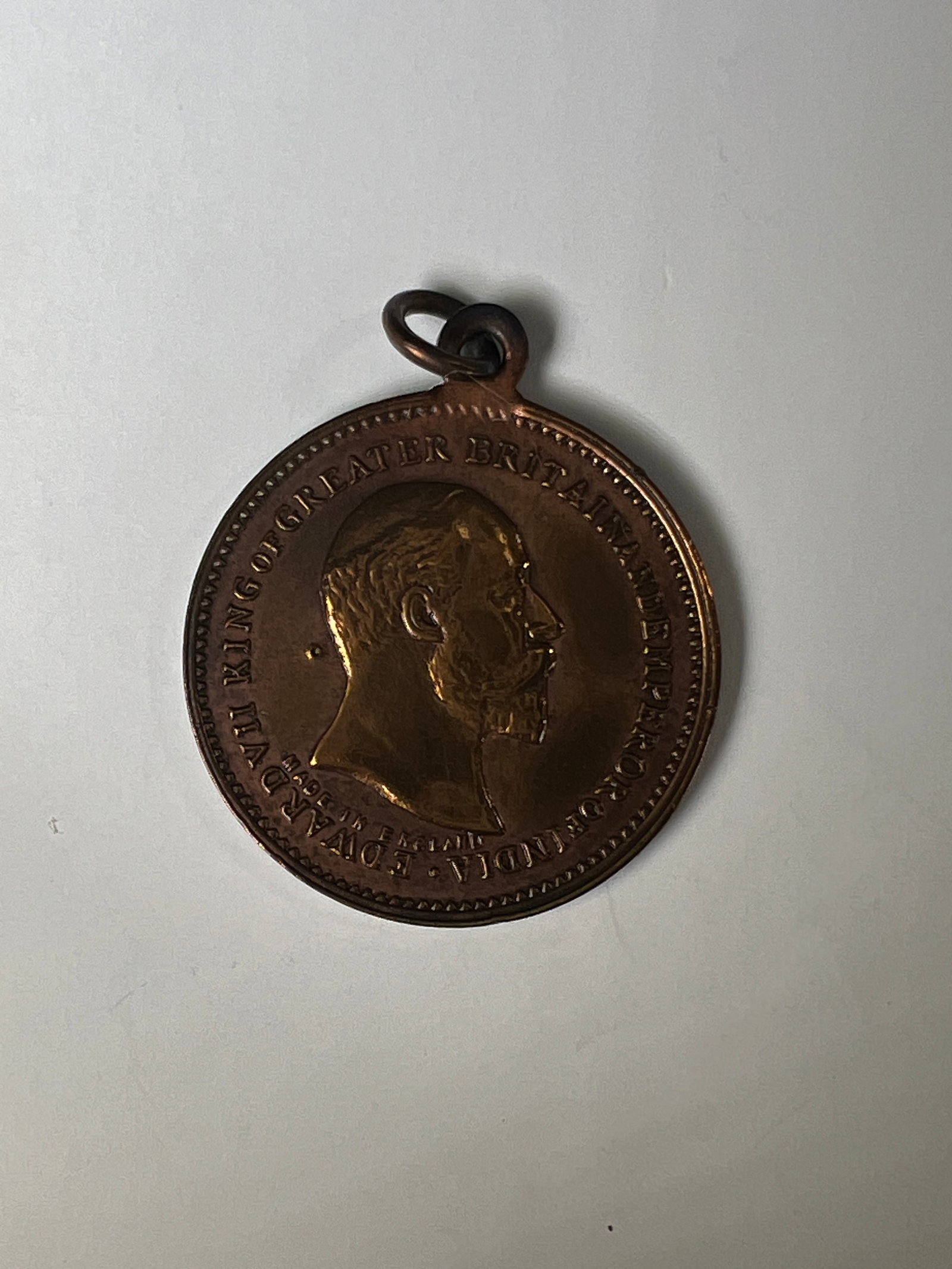 Edward VII Bronze Medal with Loop: Bronze medal featuring a portrait of Edward VII on one side and a seated figure on the other. Includes a loop for attachment.