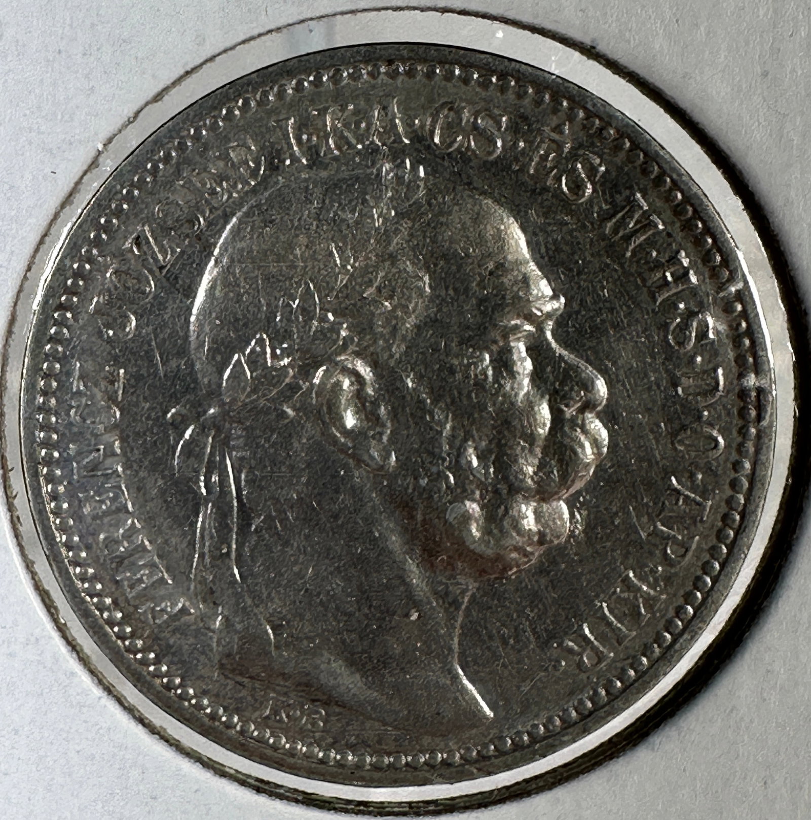 1915 Austria 1 Corona Silver Coin: 1915 Austria 1 Corona silver coin featuring a portrait of Franz Joseph I on one side and the crown of St. Stephen on the other.