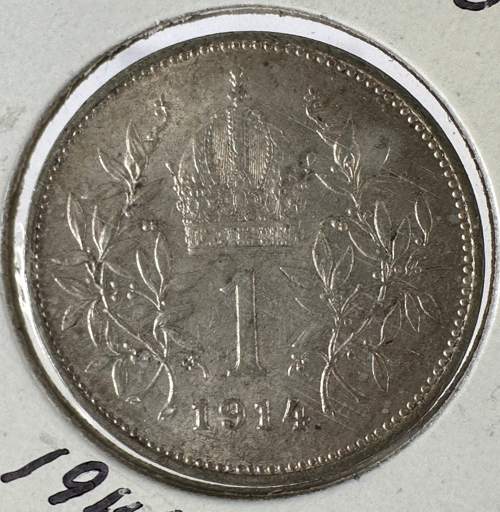 1914 Austria-Hungary Emp. 1 Corona .835 Silver Coin: 1914 Austria-Hungary Emp. 1 Corona .835 Silver Coin. Features a portrait of Franz Joseph I on one side and the crowned denomination on the other.