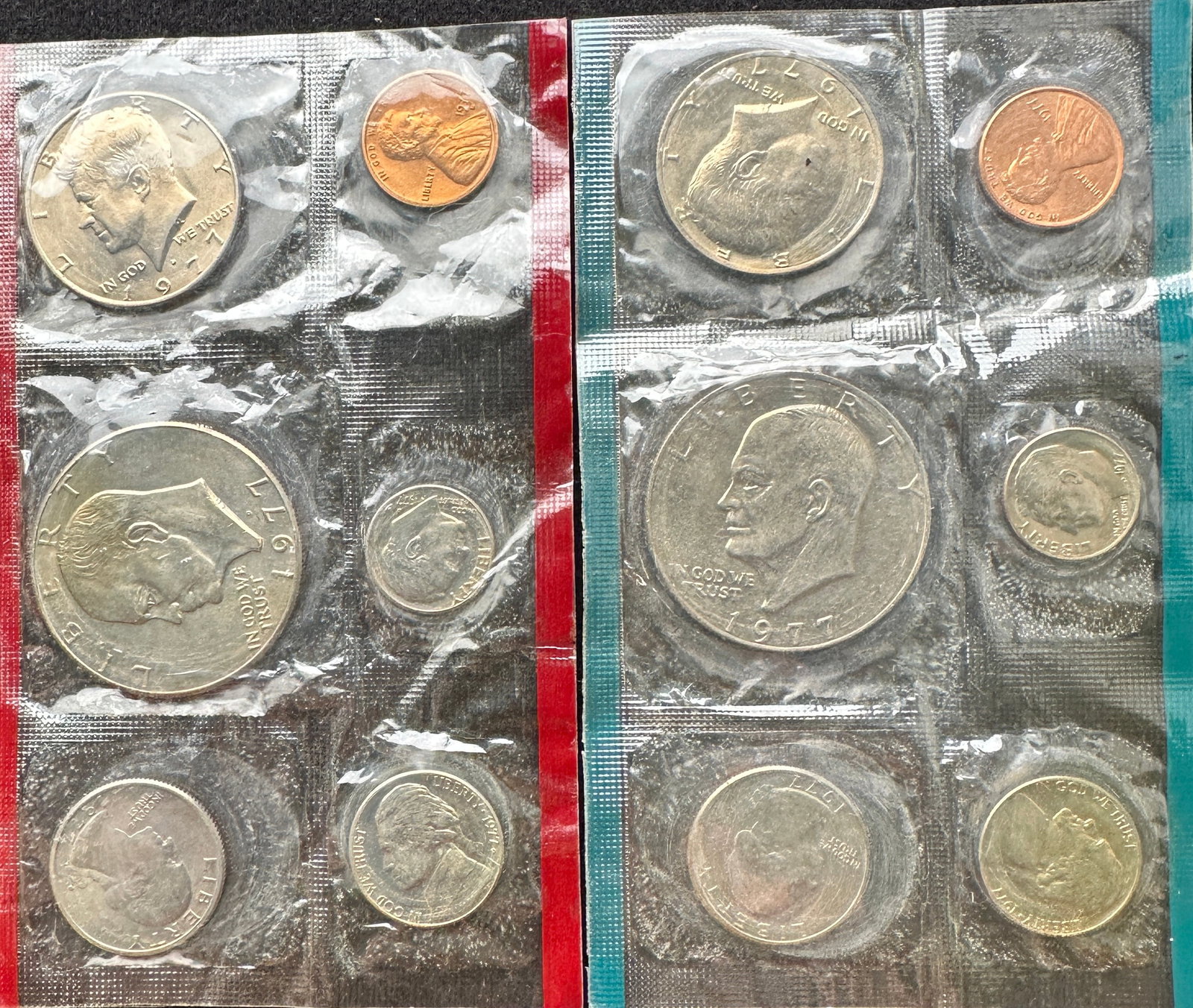 1977-D Uncirculated US Mint Coin Set: Two 1977-D uncirculated United States Mint coin sets, each containing a cent, nickel, dime, quarter, and half dollar. Housed in original packaging.