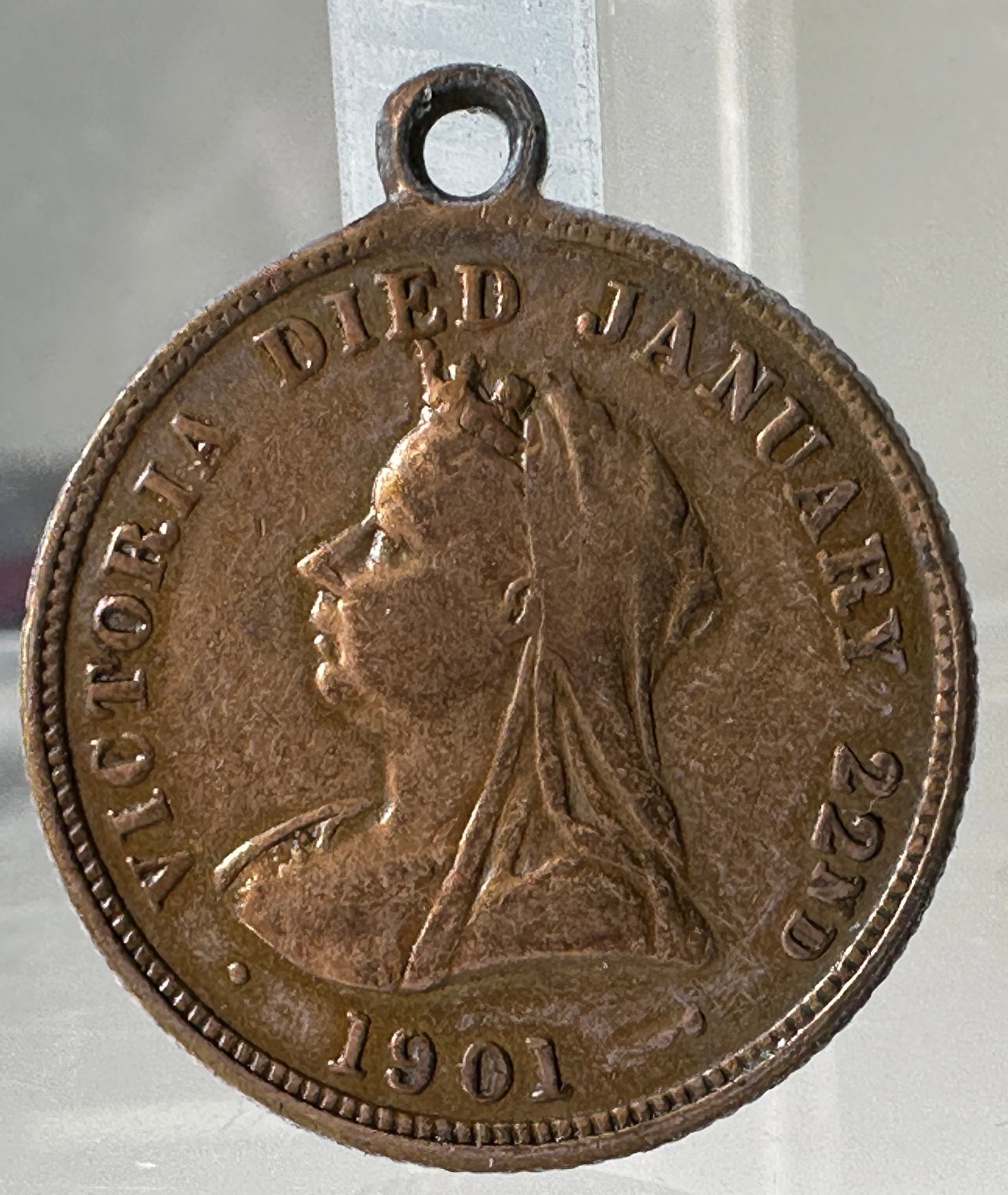 Queen Victoria Memorial Medal, 1901: Queen Victoria Memorial Medal, dated 1901. Features Queen Victoria on one side and Edward VII and Alexandra on the other. Includes a loop at the top for wear.
