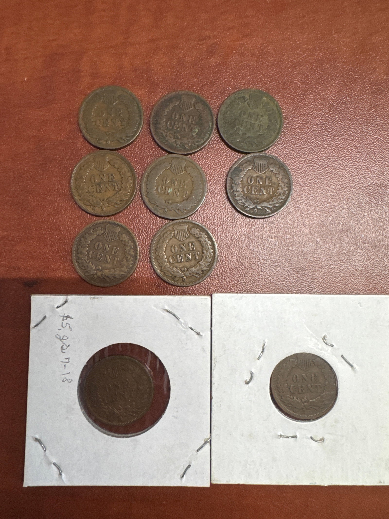 Collection of Indian Head Cents: A collection of 10 Indian Head cents, with dates ranging from 1902 to 1907. The coins are presented in protective sleeves, with two coins individually encased and labeled with their respective ye