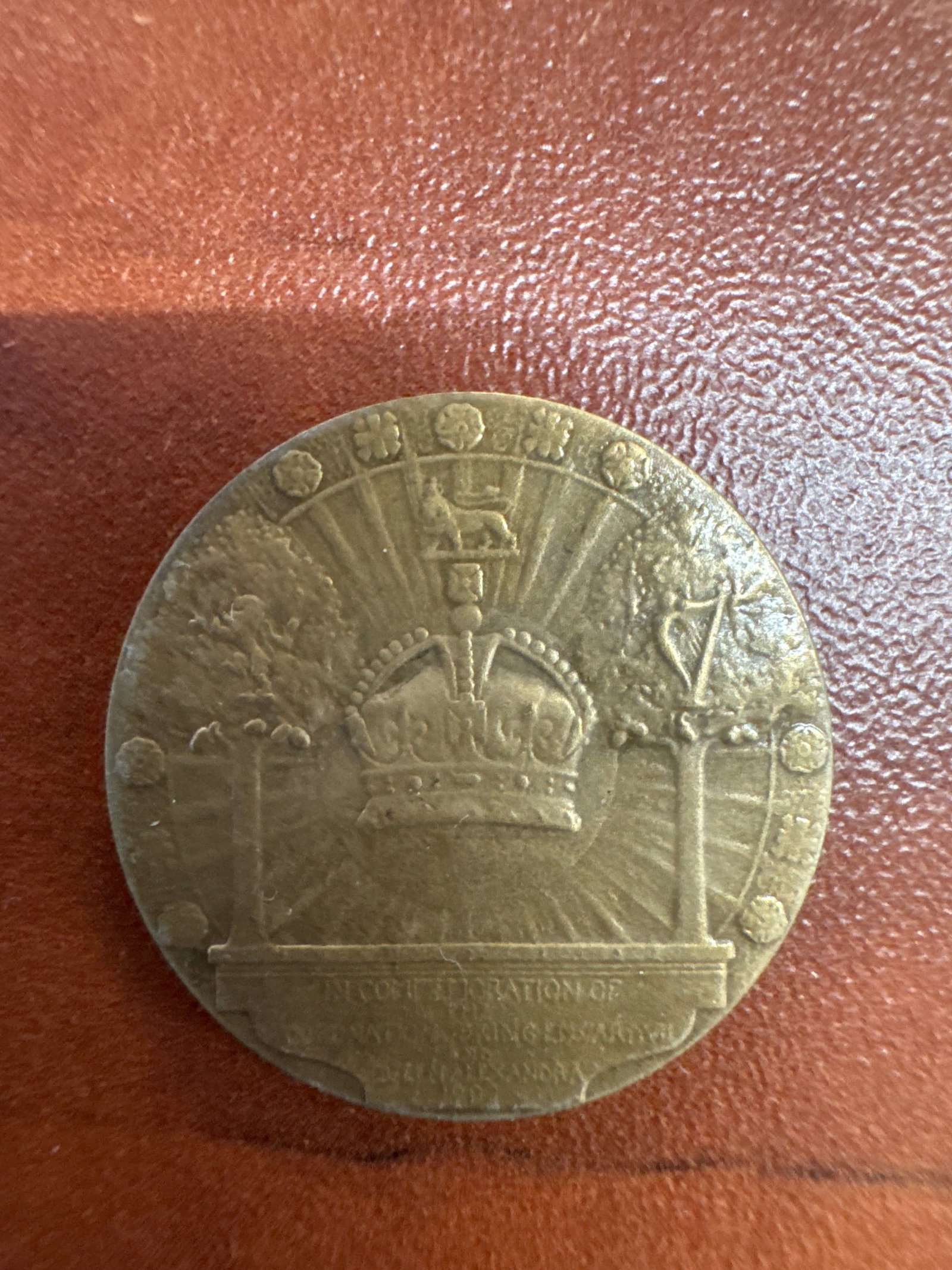 Commemorative Coin for Edward VII and Alexandra: A brass commemorative coin featuring portraits of King Edward VII and Queen Alexandra on one side, and a crown with radiant beams and floral motifs on the other. 