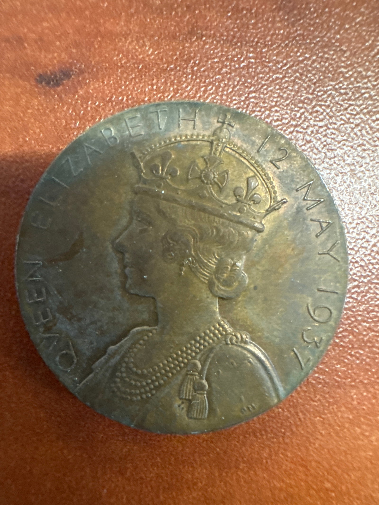 1937 Coronation Medal - King George VI & Queen Elizabeth: A commemorative medal from the 1937 coronation of King George VI and Queen Elizabeth. One side features a profile of Queen Elizabeth wearing a crown and pearls, inscribed 'QUEEN ELIZABETH 12 MAY 1