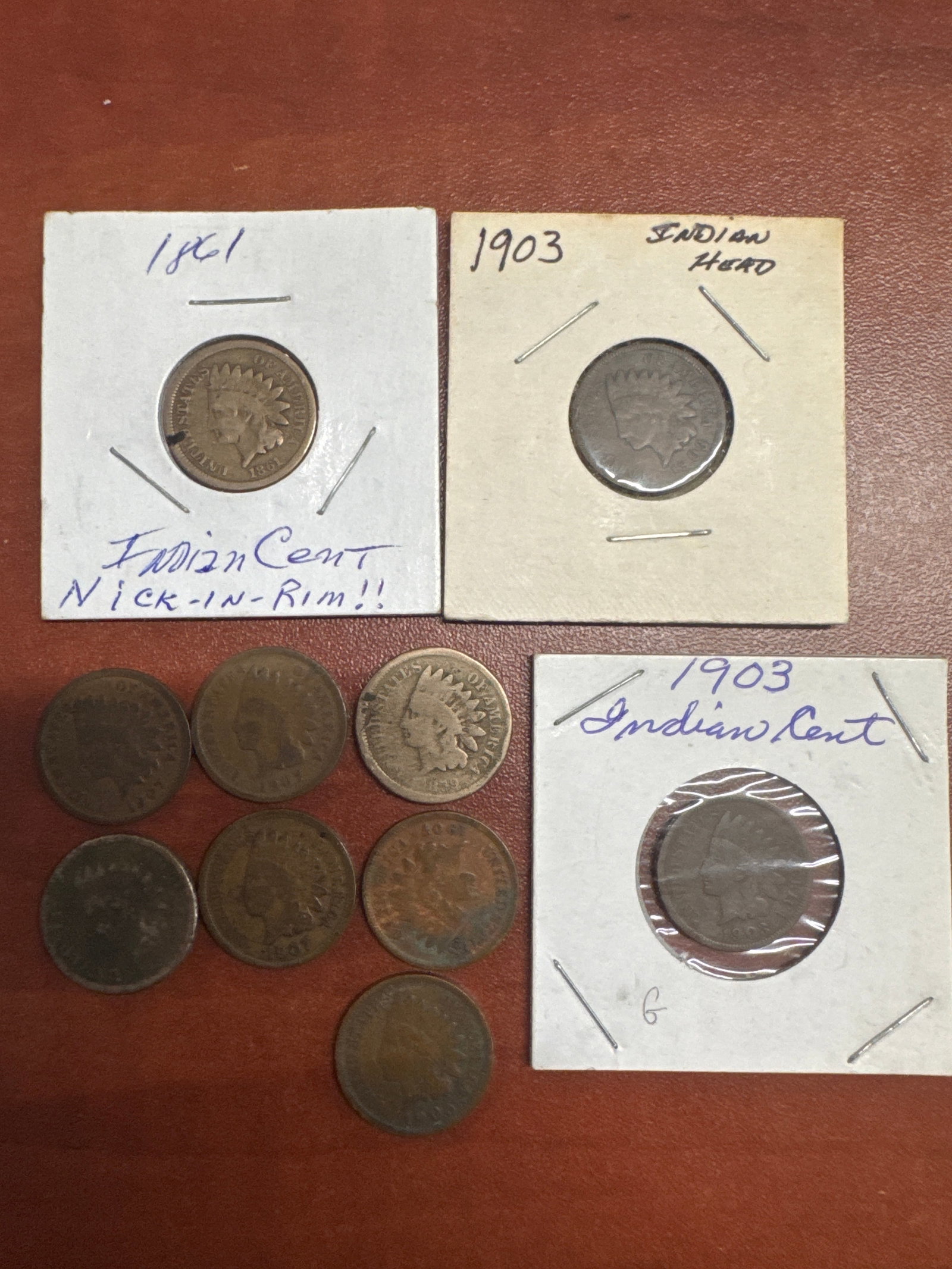 Collection of Indian Head Cents: A collection of Indian Head cents, including a 1861 cent and several 1903 cents. 