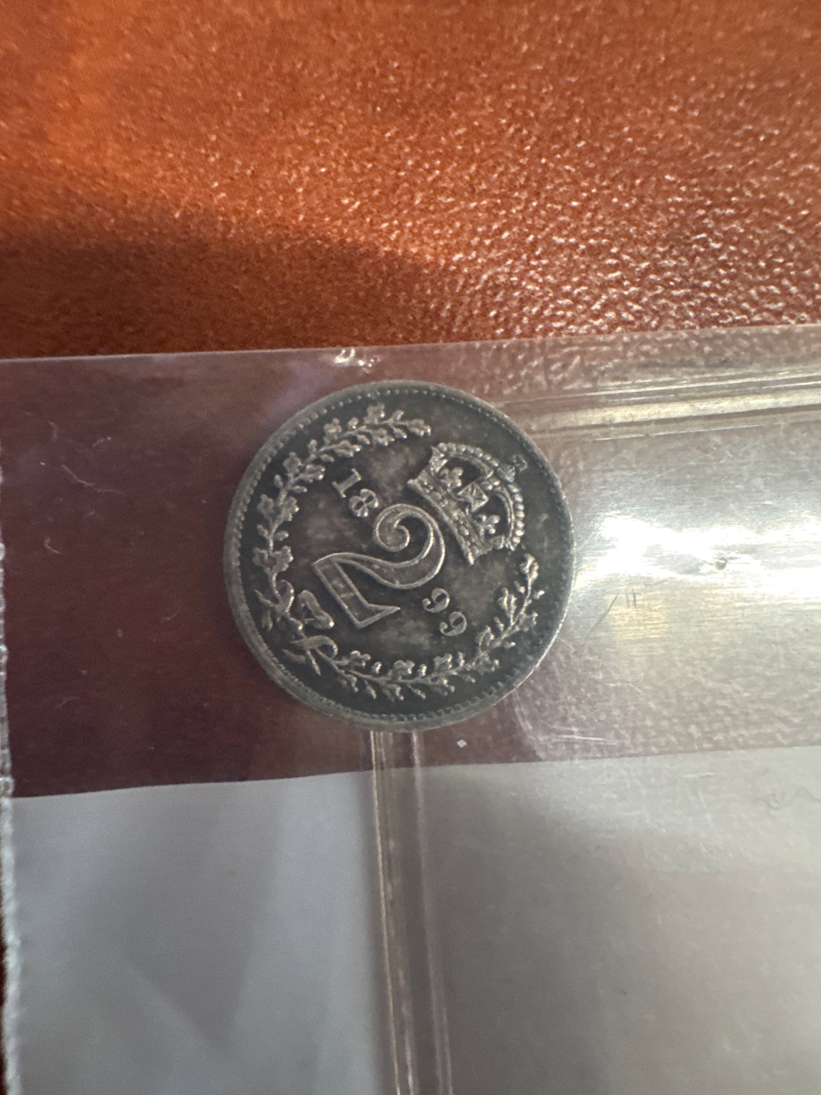 1899 Victoria Queen Silver 2 Florin Coin: A silver florin coin from 1899 featuring Queen Victoria on the obverse and a crowned shield on the reverse. The coin shows signs of wear consistent with its age.