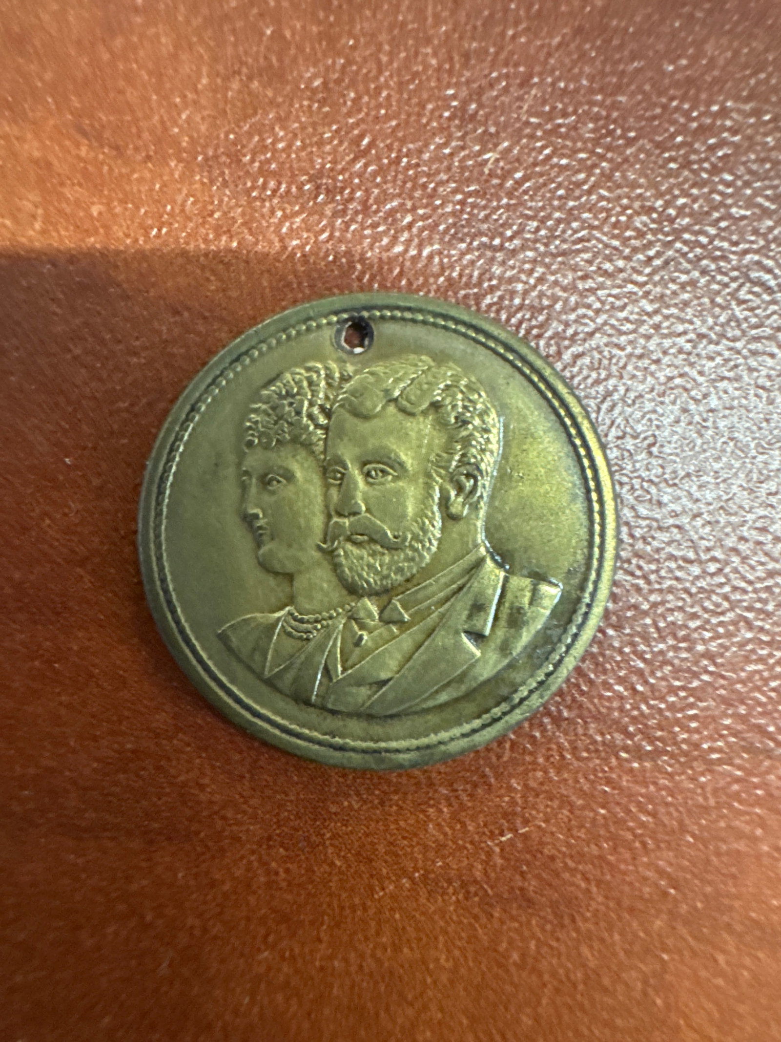 Medallion Commemorating the Marriage of HRH The Duke of York and Princess May of Teck, July 6, 1893: A commemorative medallion featuring portraits of HRH The Duke of York and Princess May of Teck. The reverse side is inscribed with 'H.R.H. THE DUKE OF YORK AND H.R.H. PRINCESS MAY OF TECK MARRIED 