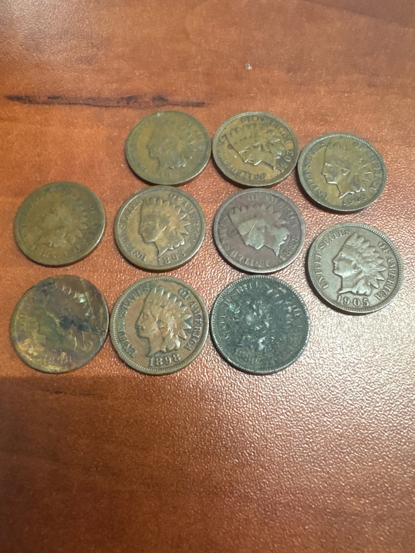 Collection of Indian Head Pennies: A collection of ten Indian Head pennies, featuring various dates including 1893, 1905, and others. 