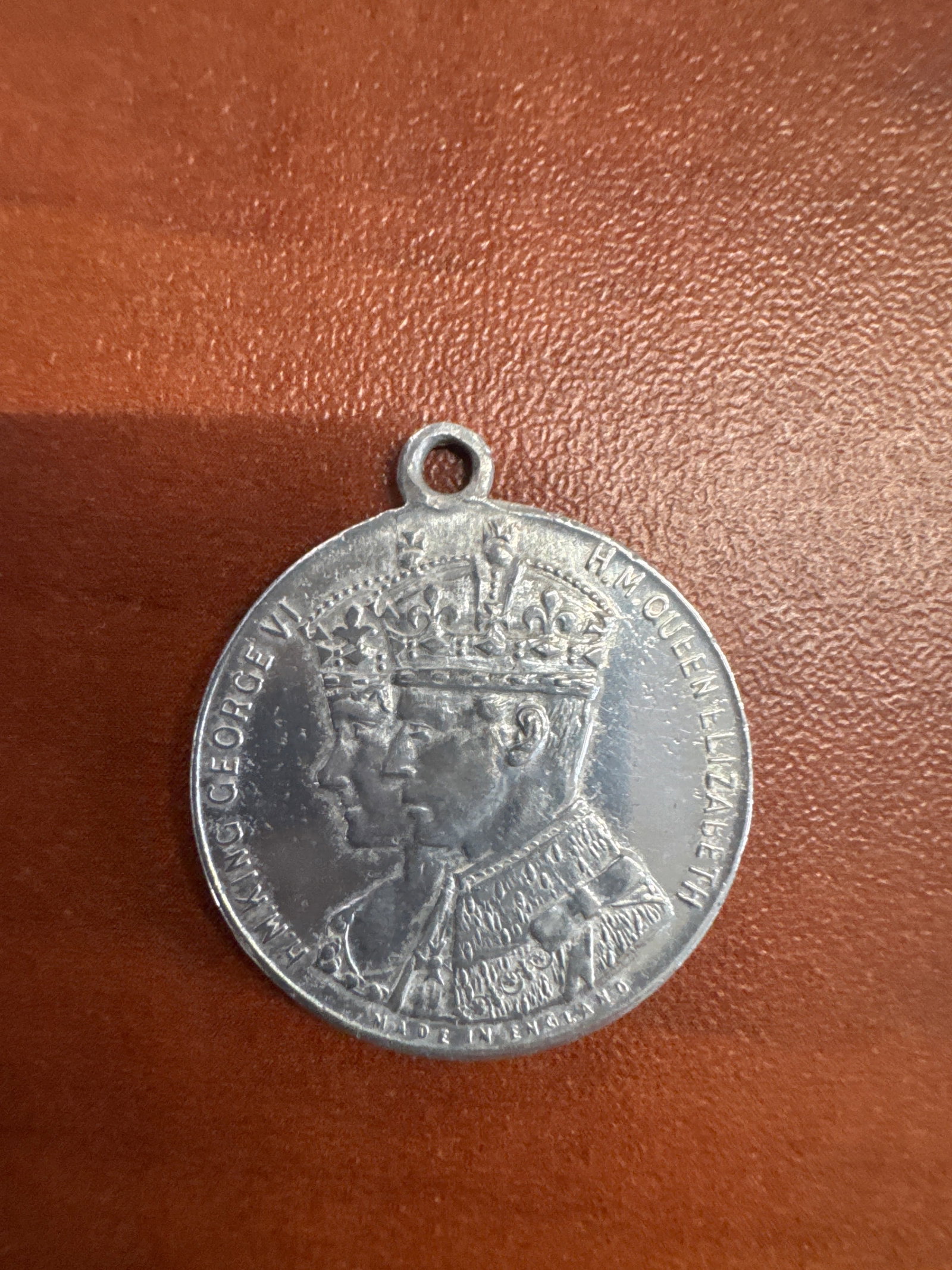 1937 Coronation Medal for King George VI and Queen Elizabeth: A commemorative medal featuring portraits of King George VI and Queen Elizabeth II on one side, and key dates of their lives and reign on the other. The reverse shows the profiles of the King and Quee