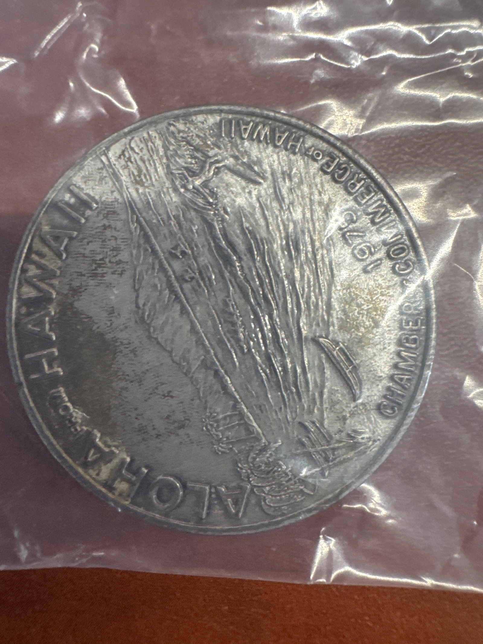 1975 Hawaii Chamber of Commerce Aloha Dollar Coin: This is a 1975 Hawaii Chamber of Commerce Aloha Dollar coin. 