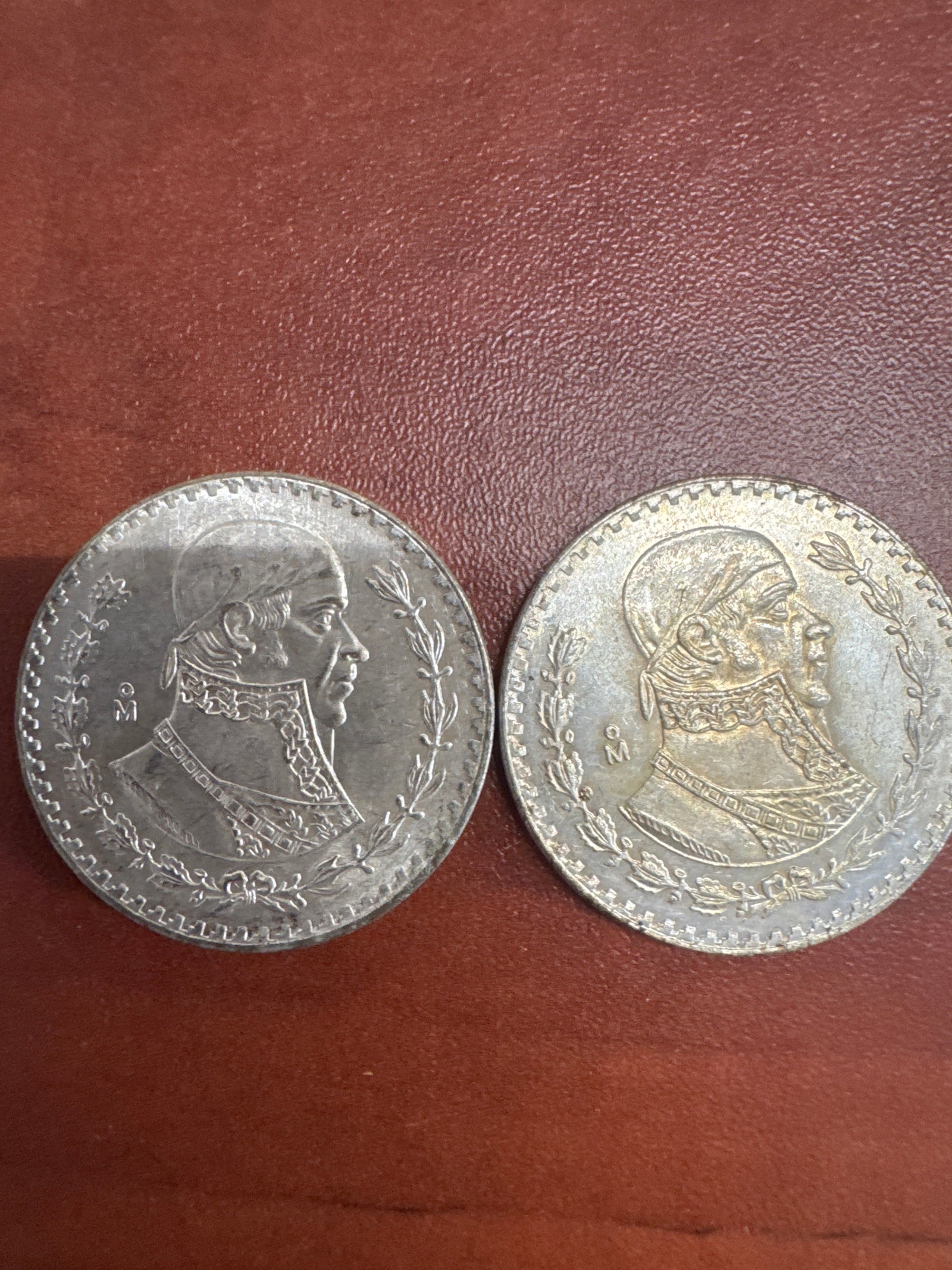 1958 Two Mexican 1 Peso Coins: This lot features two 1958 Mexican 1 Peso coins. 