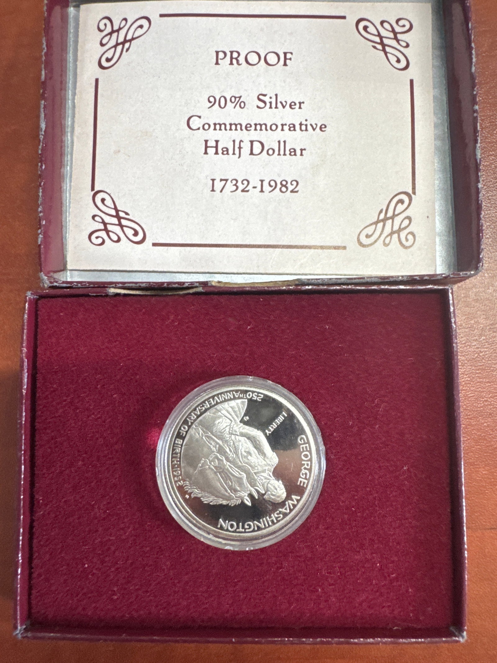 1982 George Washington 250th Anniversary Proof Silver Commemorative Half Dollar: A 1982 proof commemorative half dollar celebrating the 250th anniversary of George Washington's birth. This coin is made of 90% silver and features a portrait of George Washington on horseback on 