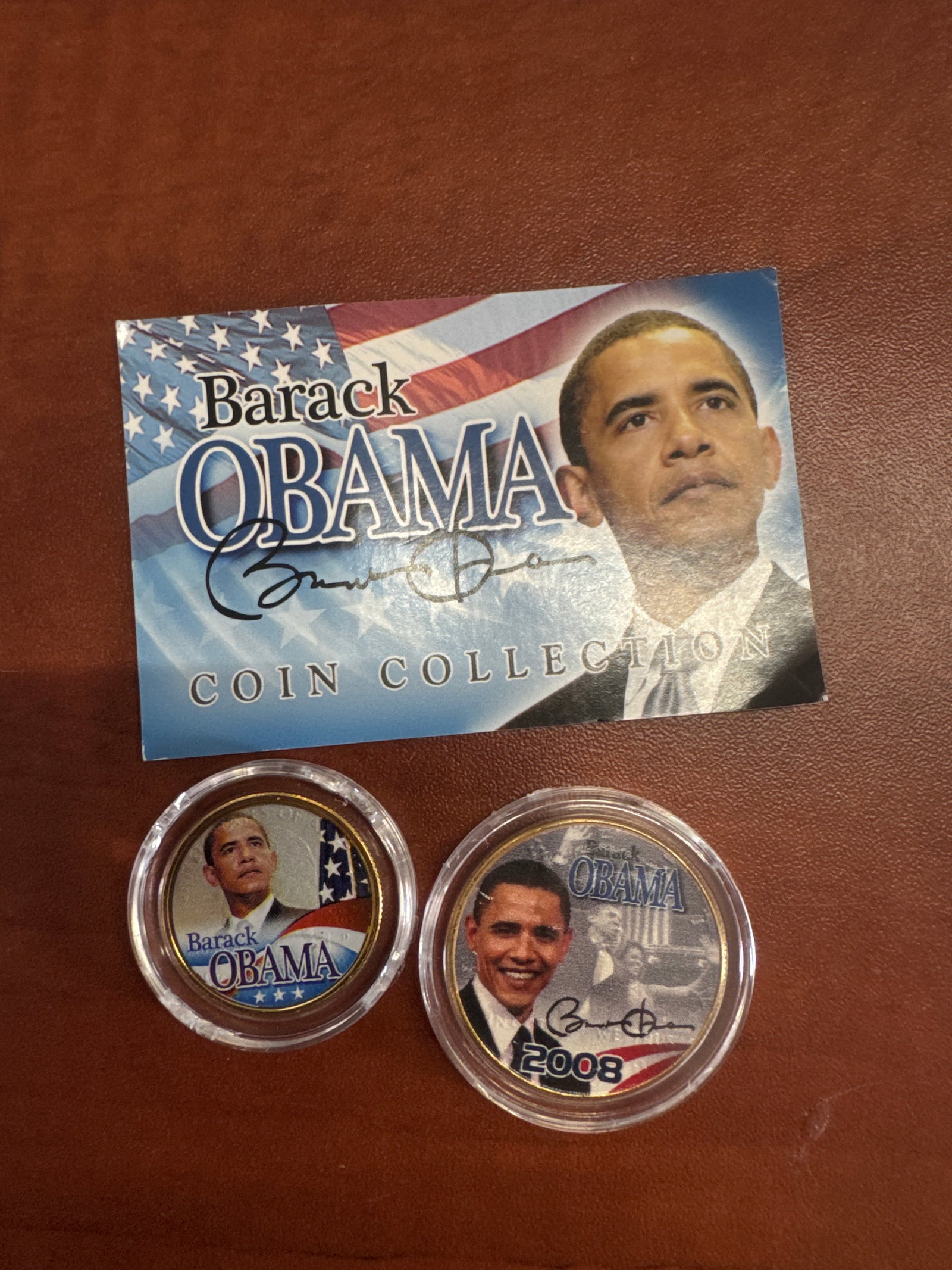 Barack Obama Coin Collection - 24KT Gold Plated Genuine Legal Tender: This collection features two 24KT gold-plated genuine legal tender United States coins, each showcasing vibrant full-color images of Barack Obama. The coins are presented with a certificate of authent