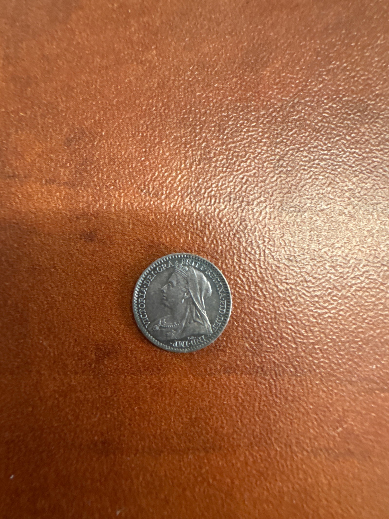 1899 British 1 Penny: 1899 British 1 Penny. The obverse features a profile of Queen Victoria, and the reverse displays the denomination '1' within a wreath and the year '1899'.
