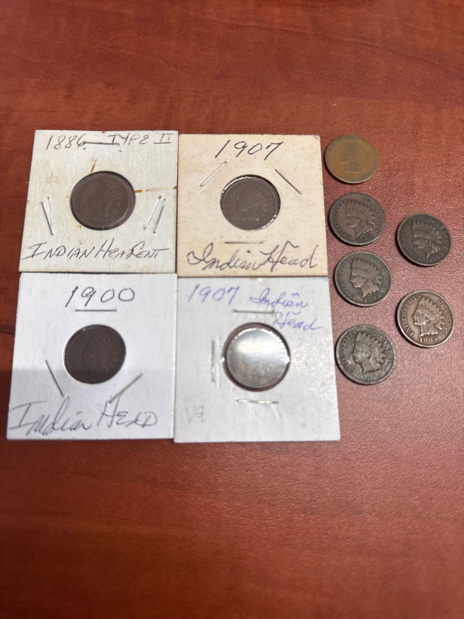 Collection of Indian Head Pennies: A collection of five Indian Head pennies, including examples from 1886 (Type II), 1900, and 1907 and more. 