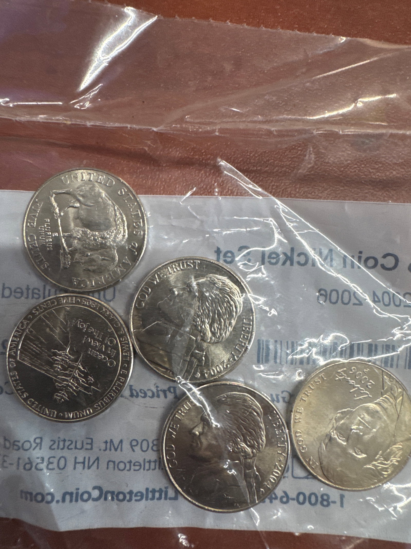 5 Coin Nickel Set 2004-2006 Uncirculated: This lot features a 5-coin nickel set from Littleton Coin Company, dated 2004-2006. The coins are uncirculated and come in their original packaging.