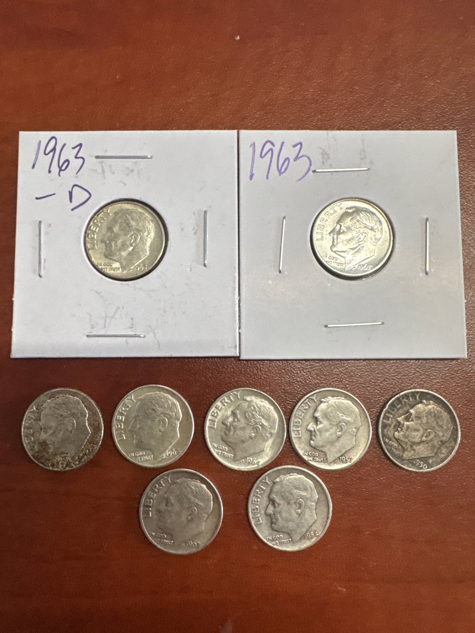 Collection of Roosevelt Dimes: This lot features a collection of 9 Roosevelt dimes. All coins are silver in color.