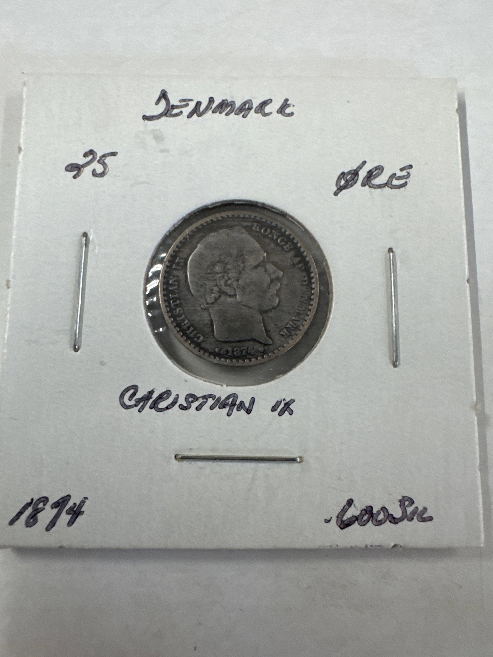 Denmark 25 Ore Coin, Christian IX, 1874: A Danish 25 ore coin featuring a profile of Christian IX on the obverse and the denomination and year on the reverse. The coin is dated 1874.