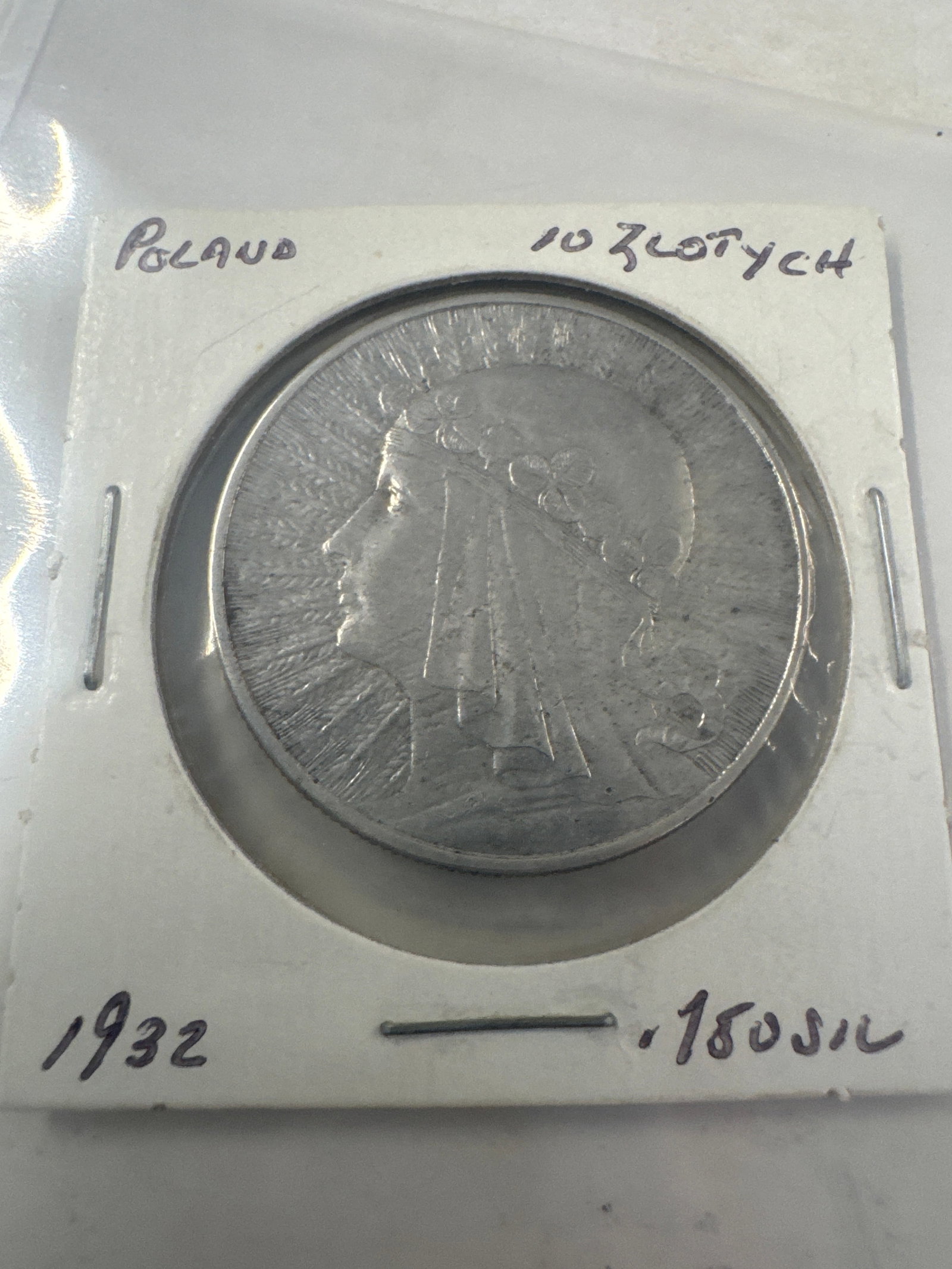 1932 Poland 10 Zlotych Coin: A silver coin from Poland dated 1932, featuring a profile of a woman on one side and an eagle crest on the other. (.750 Silver). 