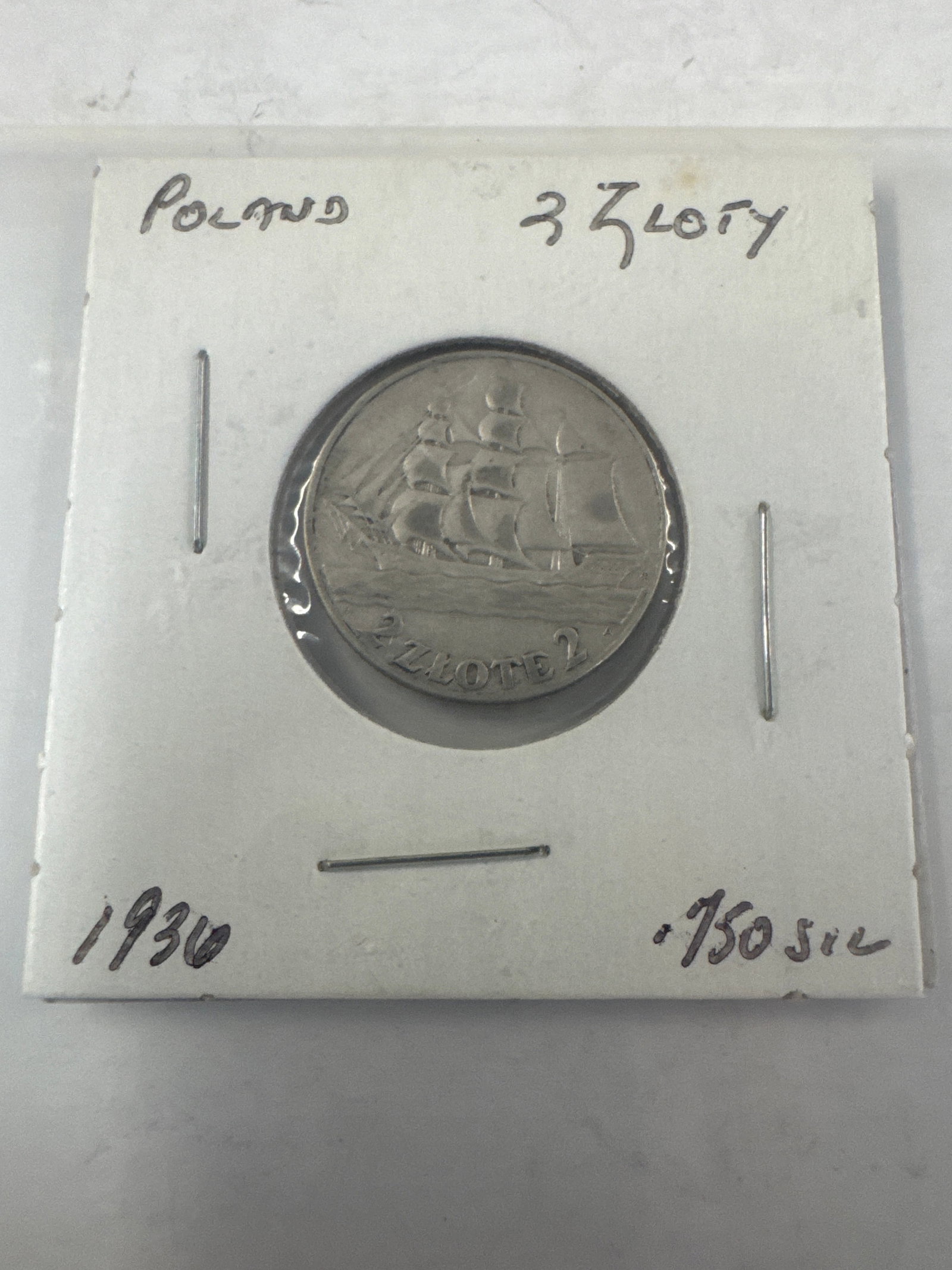 1936 Poland 2 Zloty Coin .750 Silver: A silver coin from Poland dated 1936, featuring a sailing ship on one side and an eagle crest on the other. The coin is identified as 2 Zloty. Silver .750. 