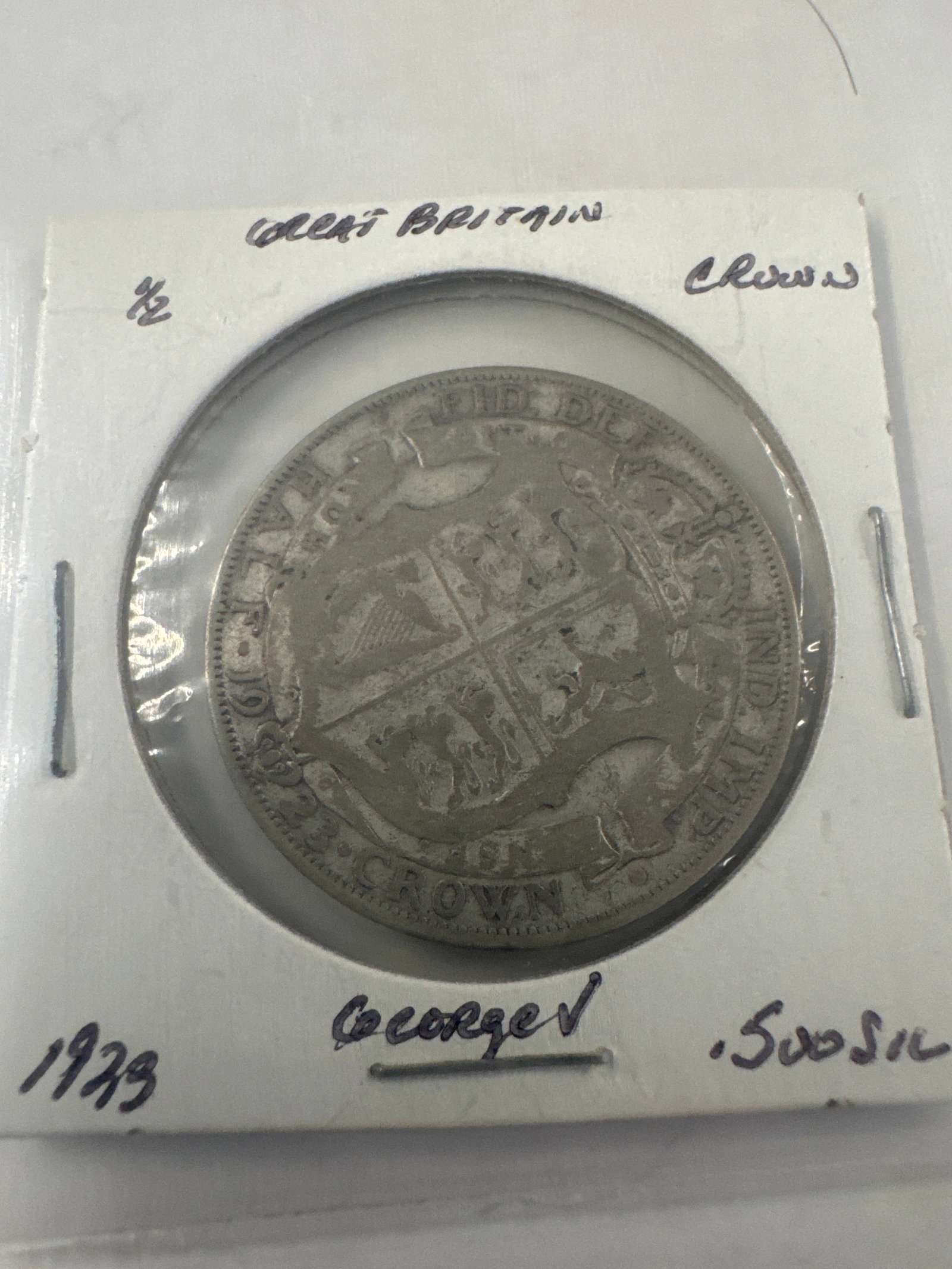 1929 Great Britain George V Silver 1/2 Crown Coin: A silver crown coin from Great Britain featuring King George V. The coin is dated 1929 and appears to be in good condition with visible details of the monarch's profile and the royal crest.