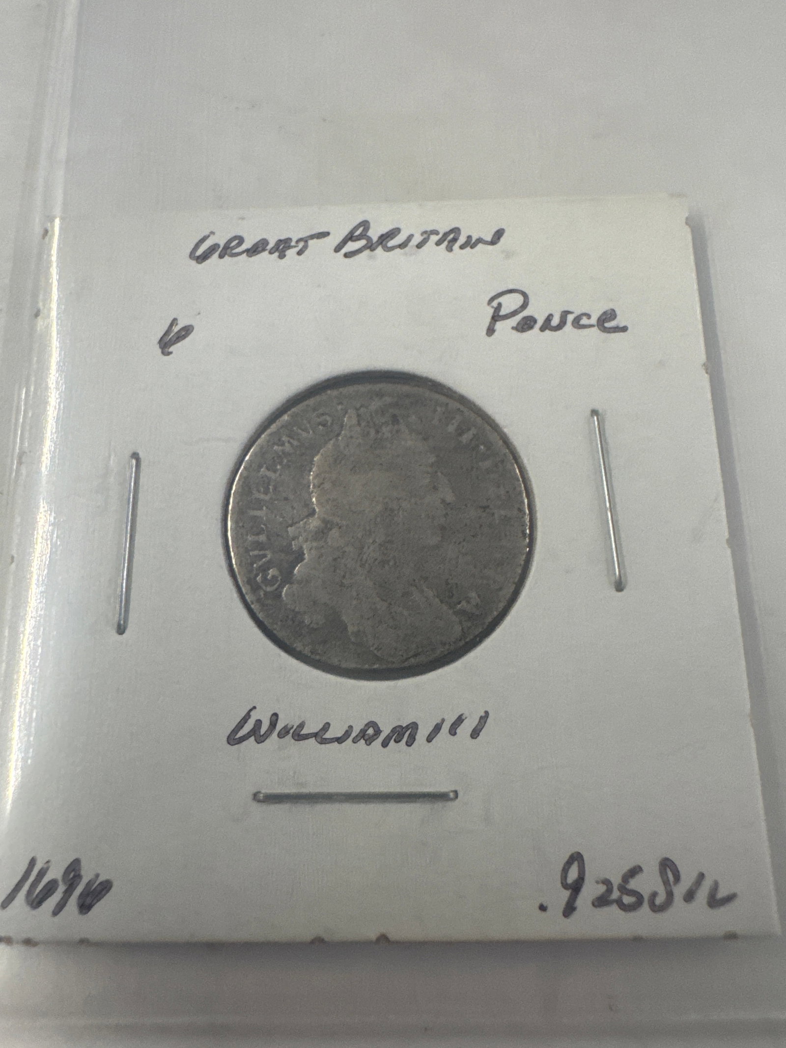 Great Britain 1696 William III Silver Penny Coin: A silver penny coin from Great Britain, featuring a portrait of William III. The coin is dated 1696 and appears to be in good condition for its age. The inscription "GVLIELMVS" is visible on
