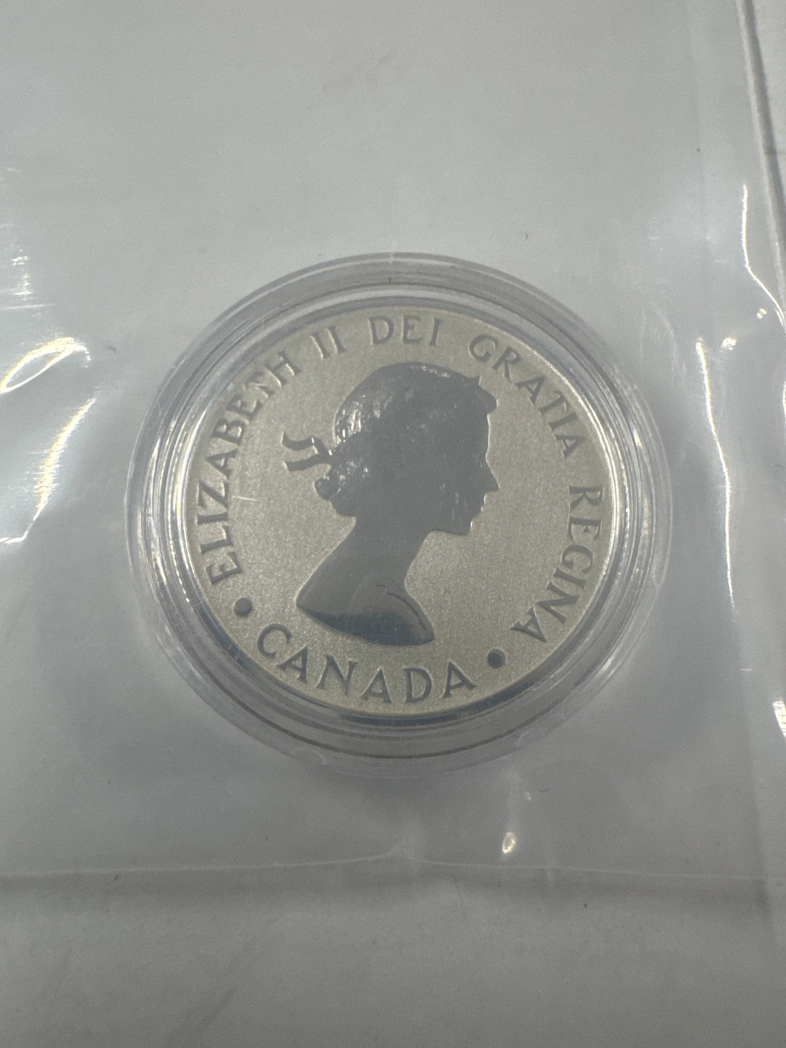 Canada 2012 $20 Fine Silver Coin: This 2012 Canadian $20 fine silver coin commemorates the 60th anniversary of Queen Elizabeth II's reign. The obverse features a portrait of Queen Elizabeth II, while the reverse displays a differe