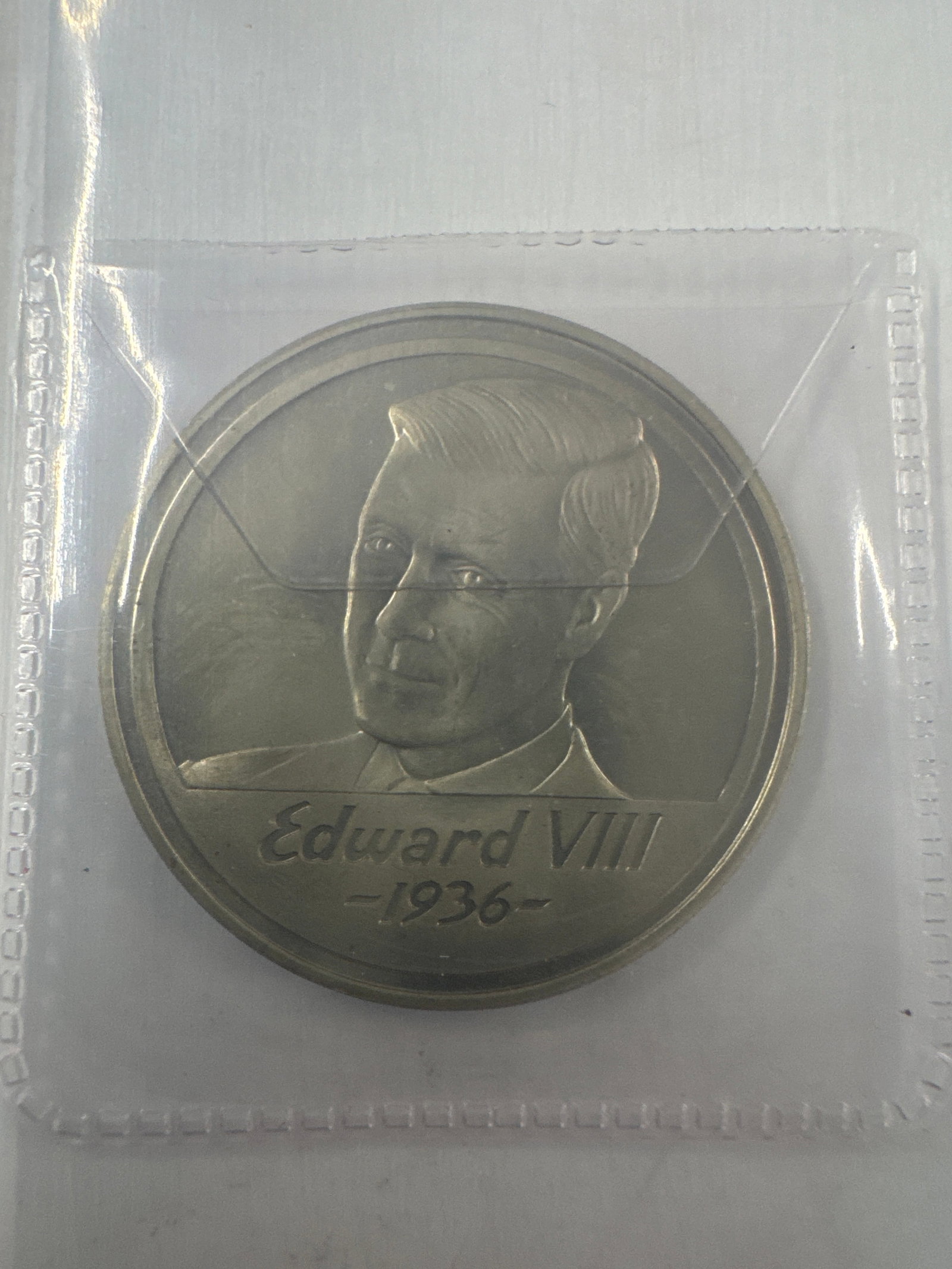 Commemorative Coin: The Three Kings of 1936: A commemorative coin featuring a portrait of Edward VIII on one side, with the inscription 'Edward VIII - 1936'. The reverse side is inscribed 'The Three Kings of 1936-1996 Anniversary'