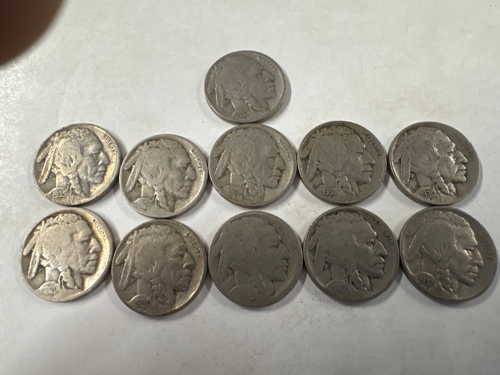 Collection of 11 Buffalo Nickel Five Cents Coins: This lot features eleven Buffalo Nickel coins, each representing five cents. The coins display the iconic American bison on one side and a Native American profile on the other. 