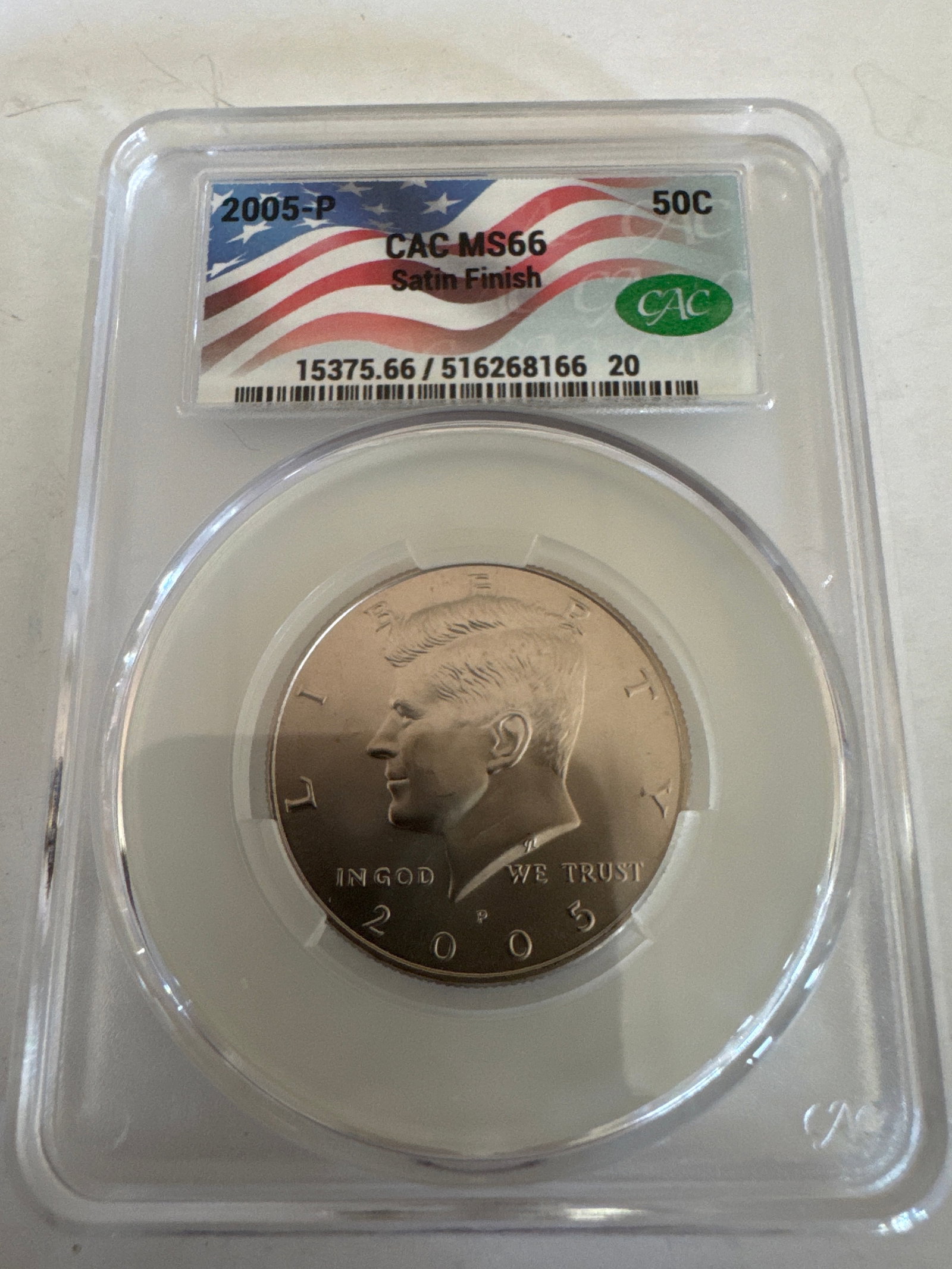 2005-P Kennedy Half Dollar CAC MS66 Satin Finish: A 2005-P Kennedy Half Dollar graded MS66 with a Satin Finish by CAC. This coin features the profile of John F. Kennedy on the obverse and the Presidential Seal on the reverse.