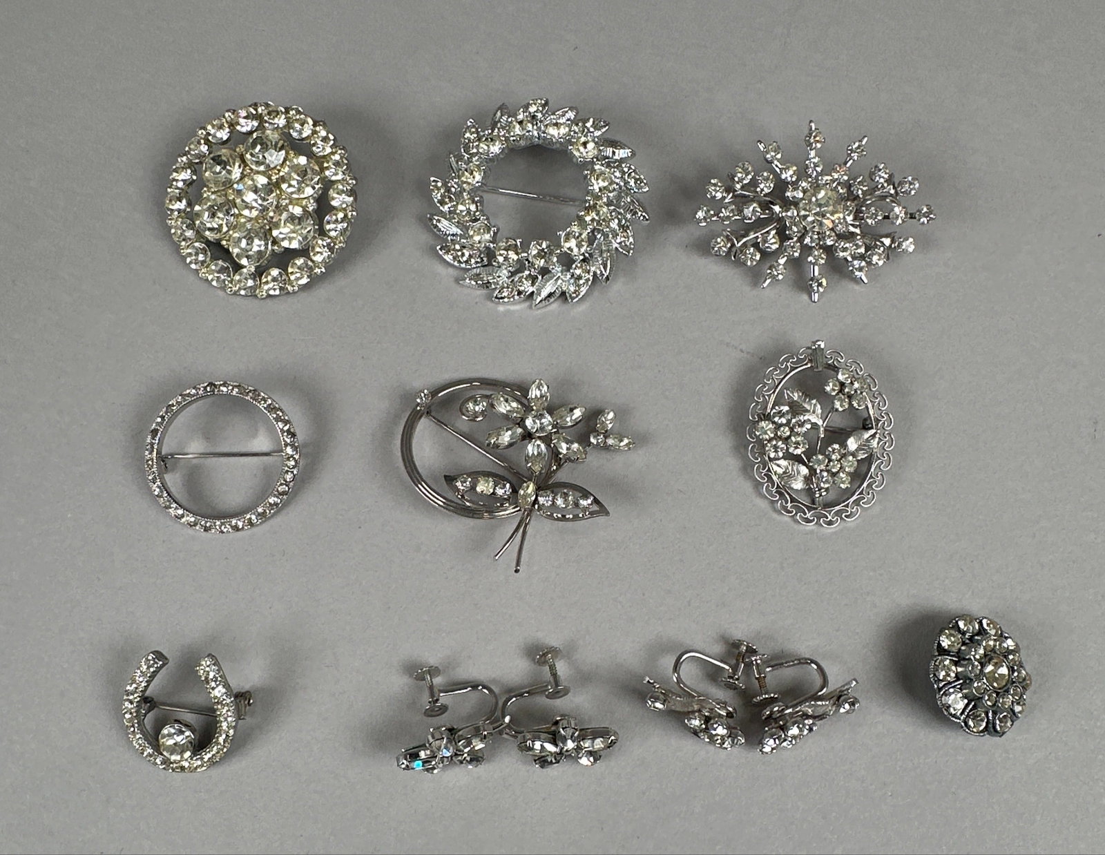Vintage Rhinestone Earrings & Pins/Brooches, Krementz: A collection of ten vintage costume jewelry pieces, including brooches and earrings, all adorned with sparkling rhinestones. The set features various designs such as floral motifs, a horseshoe, a
