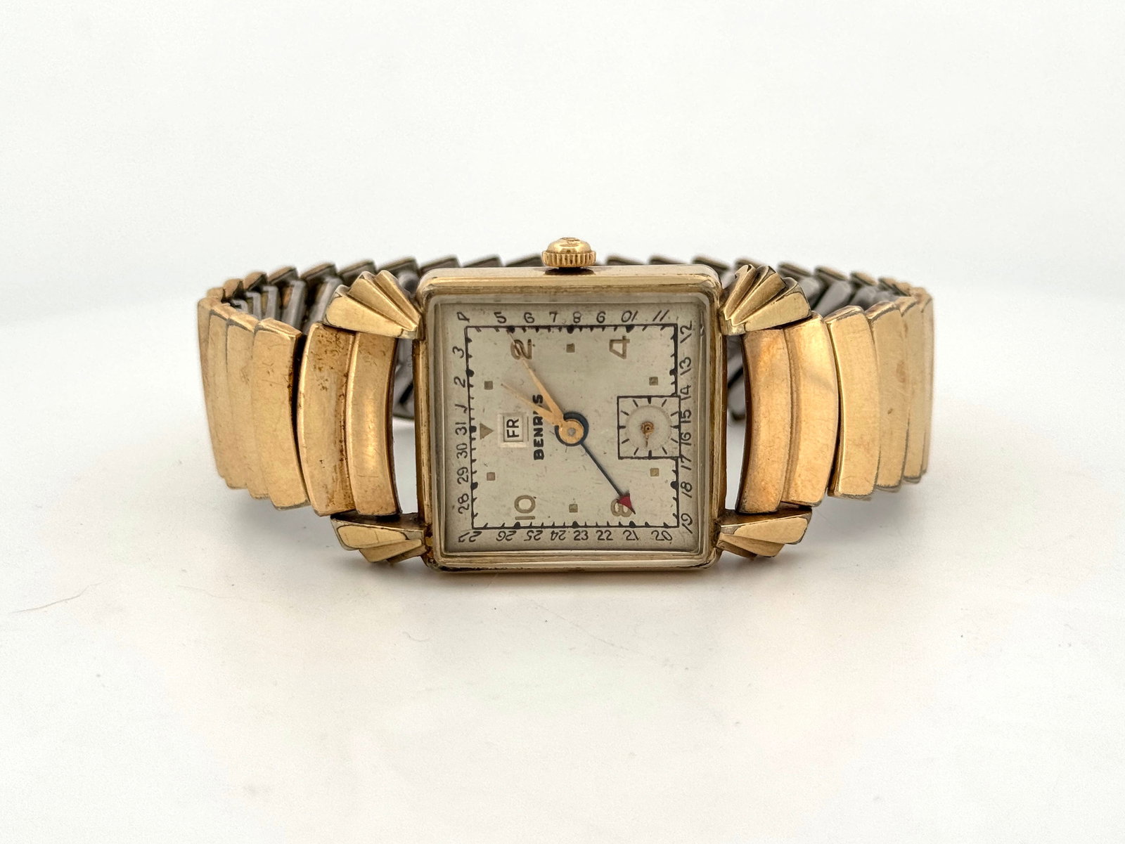 Vintage Benrus 10k Rolled Gold Plate Day Date Wristwatch: Vintage Benrus wristwatch featuring a square 10k rolled gold plated case and band. The dial displays day and date. Watch head size: 4 x 2.5 cm approx.