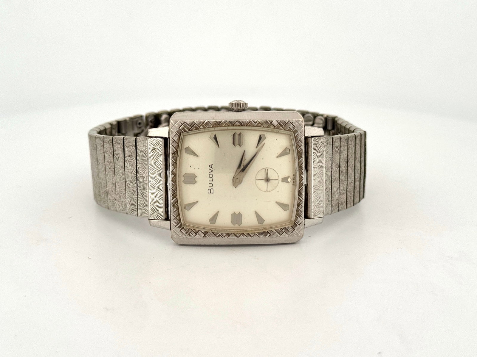 Vintage Bulova Ladies' Rolled Gold Bezel Wristwatch: Vintage Bulova ladies' wristwatch with a square face, rolled gold bezel and textured band. The watch features a mechanical movement. Sold as is. Watch head size: 3.7cm approx. 