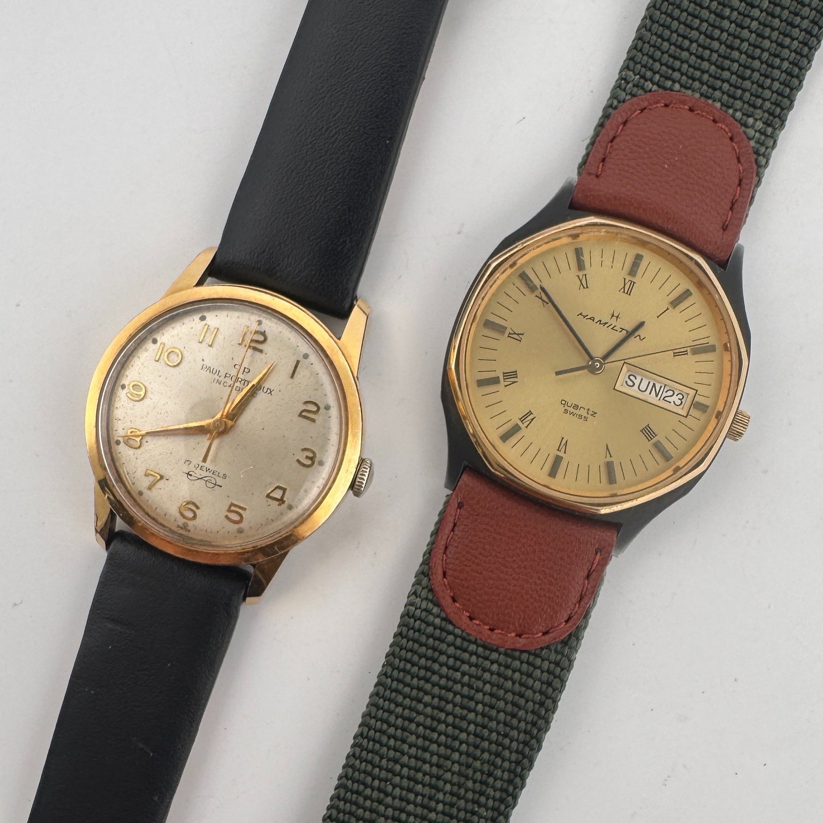 Two Vintage Watches: Hamilton and Portineaux: This lot features two vintage watches. The first is a Hamilton Quartz Swiss Made wristwatch with a gold-tone dial, Roman numeral markers, and a day/date window. It has a base metal bezel and