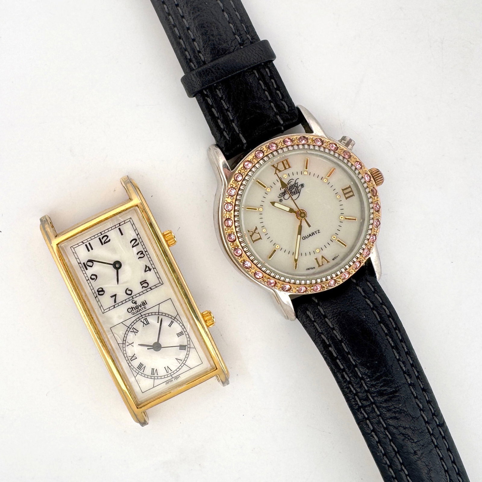 Cheval Dual Time Zone Quartz Desk Clock and Kirks Folly Quartz Watch: A Cheval dual time zone quartz desk clock with a gold-tone case and mother-of-pearl style faces, featuring Japan movement. Also included is a Kirks Folly quartz wristwatch with a white dial, Roman num