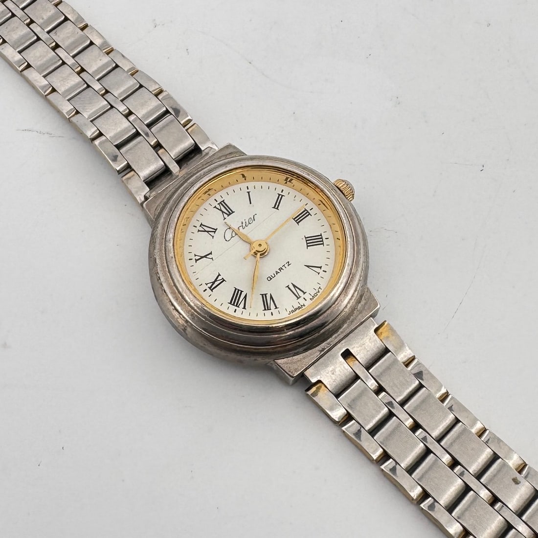 Ladies' Cartier Style Quartz Wristwatch: Ladies' wristwatch with a silver-tone band and case, featuring a white dial with Roman numeral markers and 'Cartier' signature. Quartz movement. Weight: 1.1oz. Size: 1'' x 2.25'
