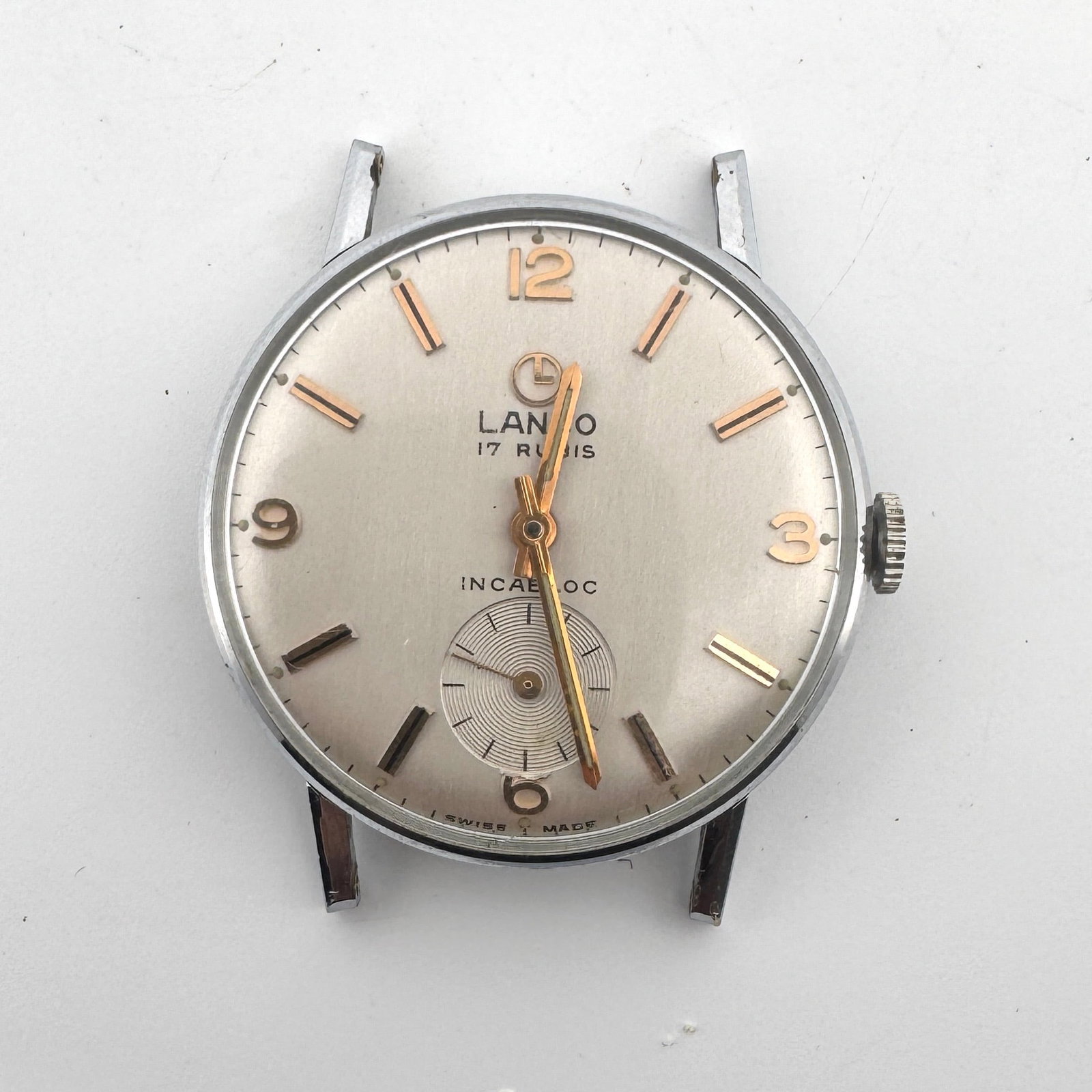 Vintage Lanco 17 Jewels Incabloc Manual Wind Watch - For Parts/Restoration: This vintage Lanco watch features a silver dial with gold-tone hour markers and hands, a sub-dial for seconds, and '17 JEWELS INCABLOC' text. The case measures approximately 4 x 3.8 cm and req